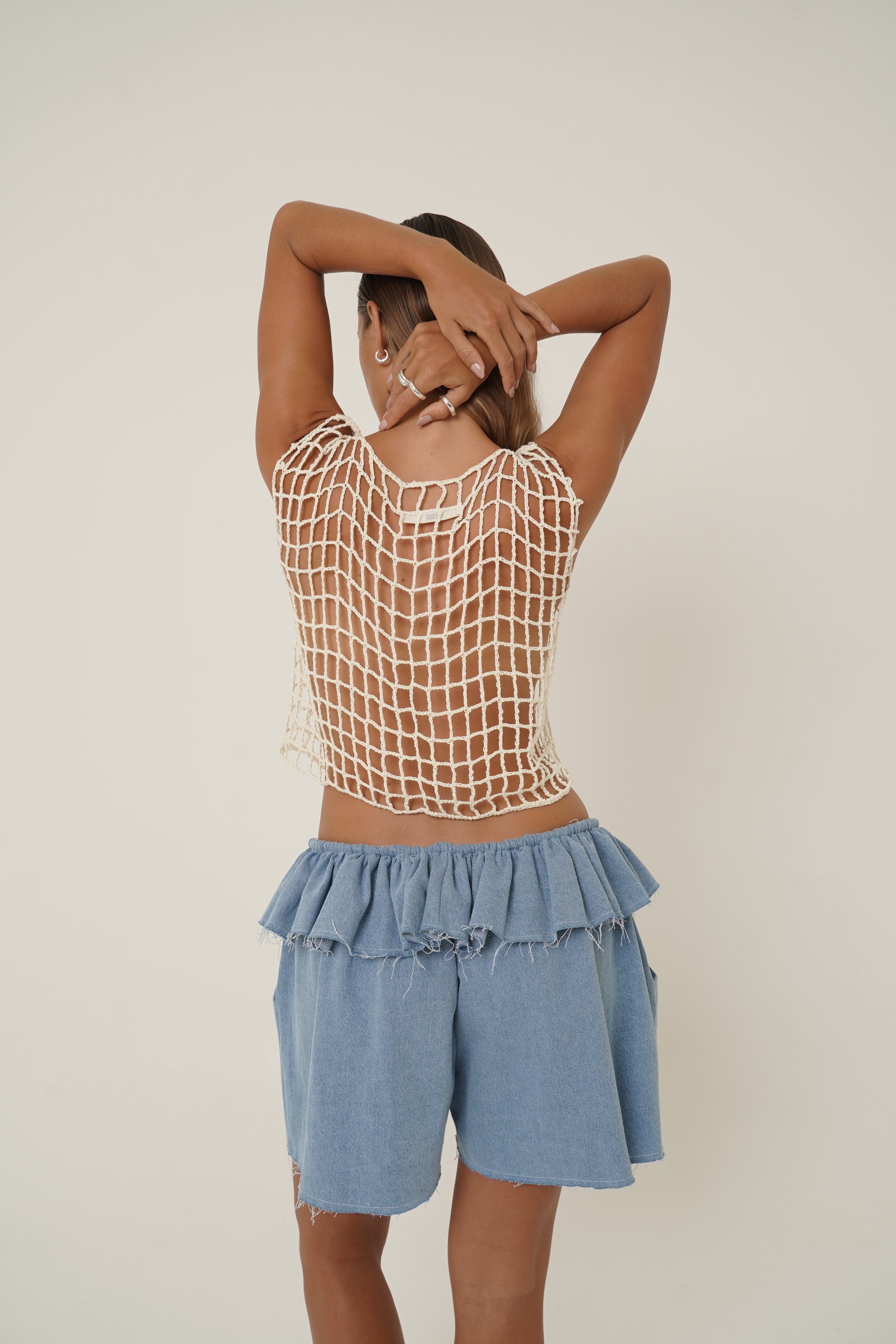 Renata Short in raw denim back view wearing crochet Carapace top from Sutura Studio
