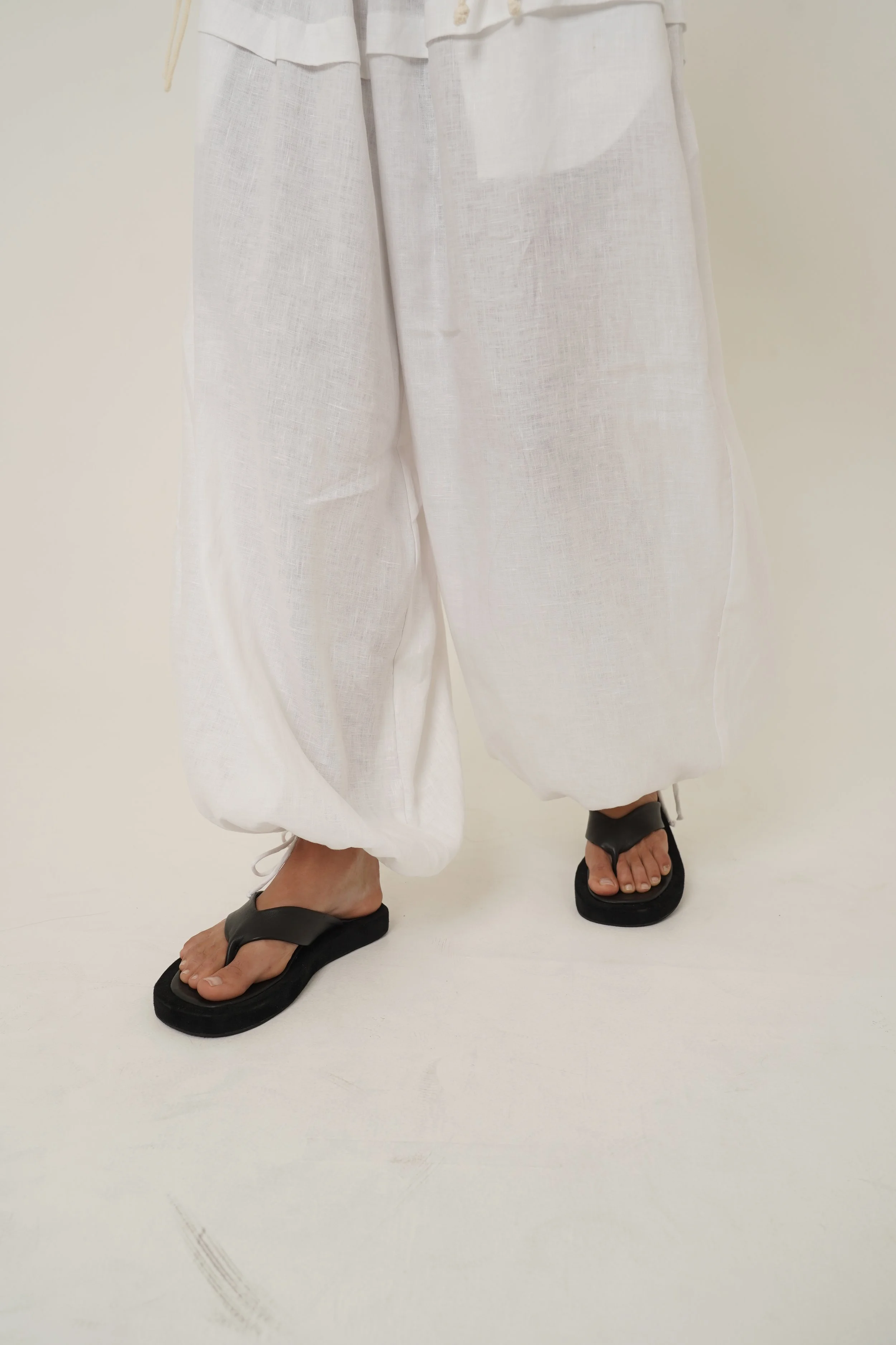 Detail of Kaos linen pants front view