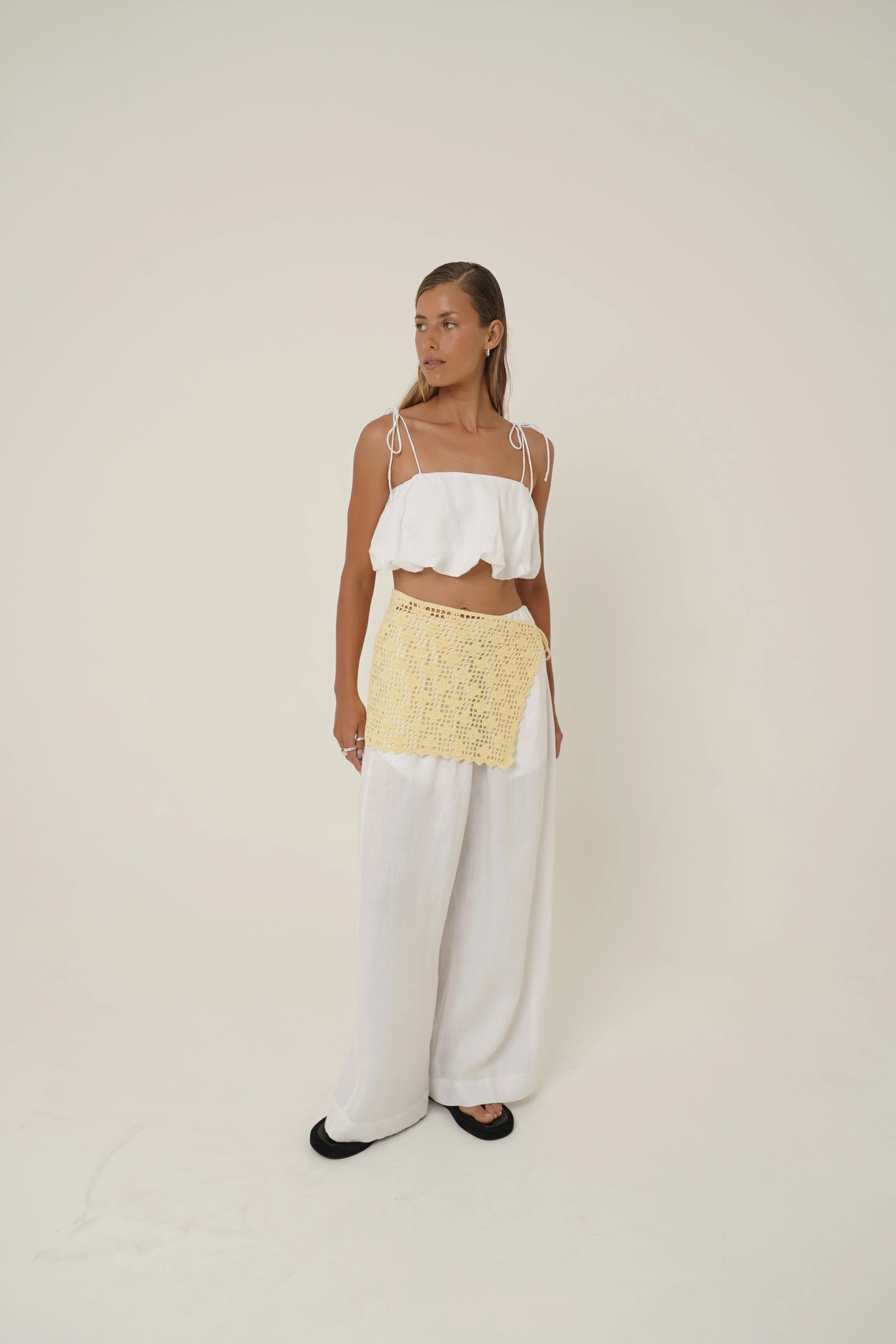 Woman wearing white linen Crescendo Set with Labelle Crochet Sarong