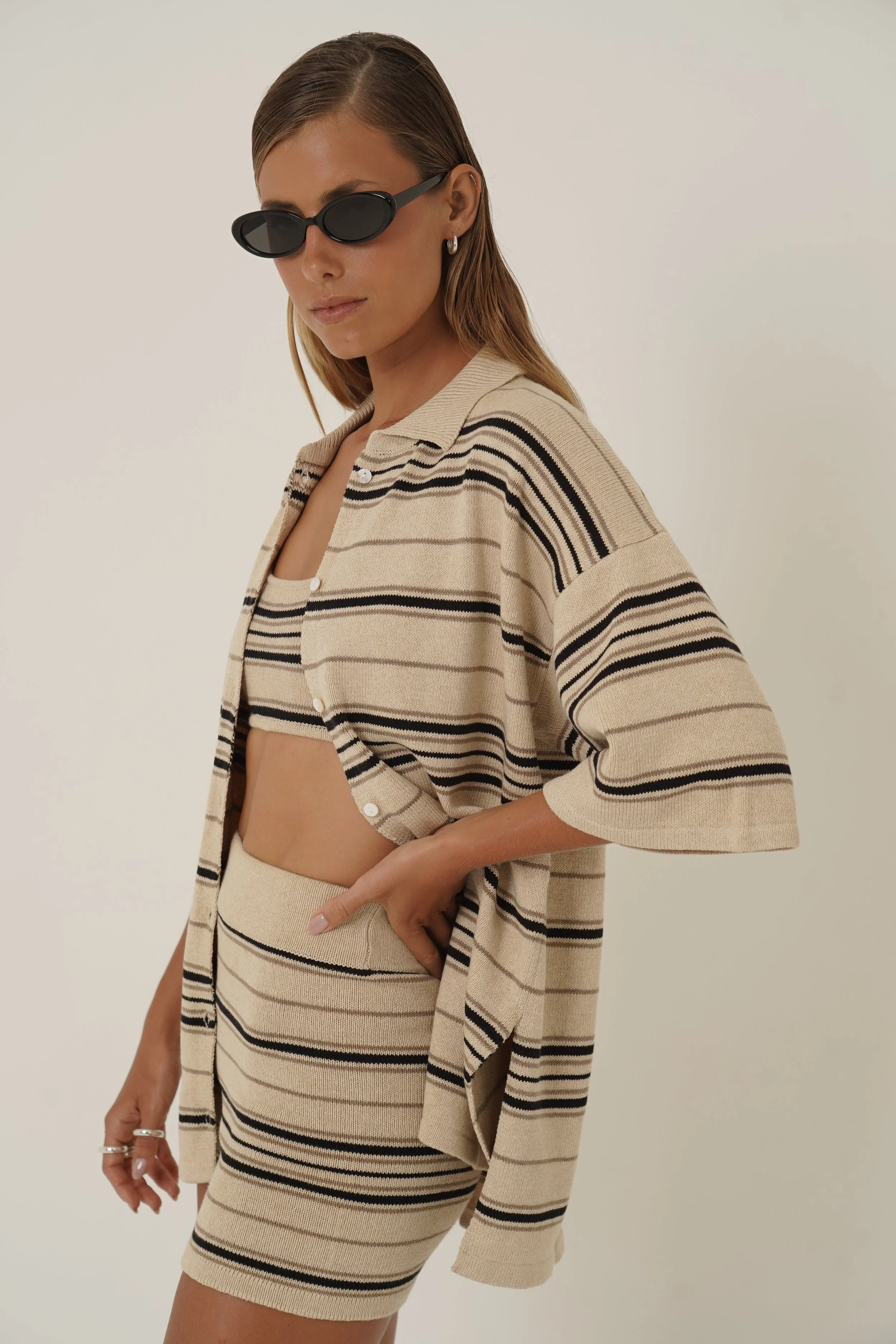 Woman wearing Dune Shirt and Top with striped pattern in cotton knit an sunglasses - side view
