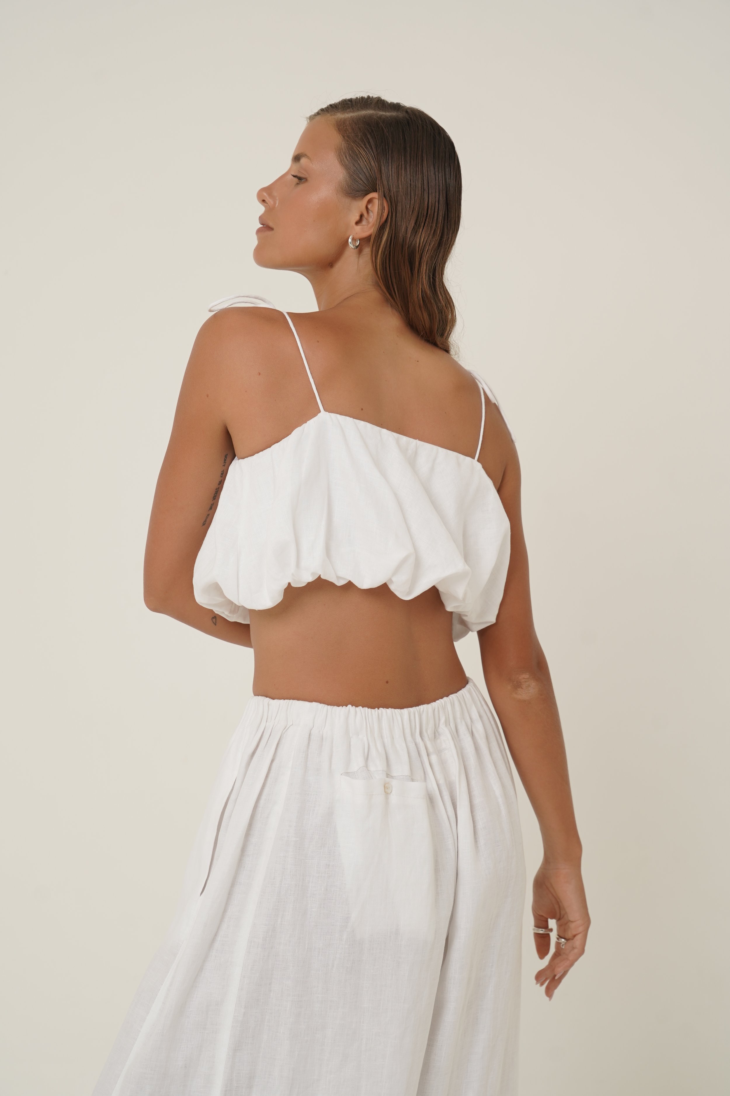 Woman wearing linen Crescendo Top with shoulder straps and double layer