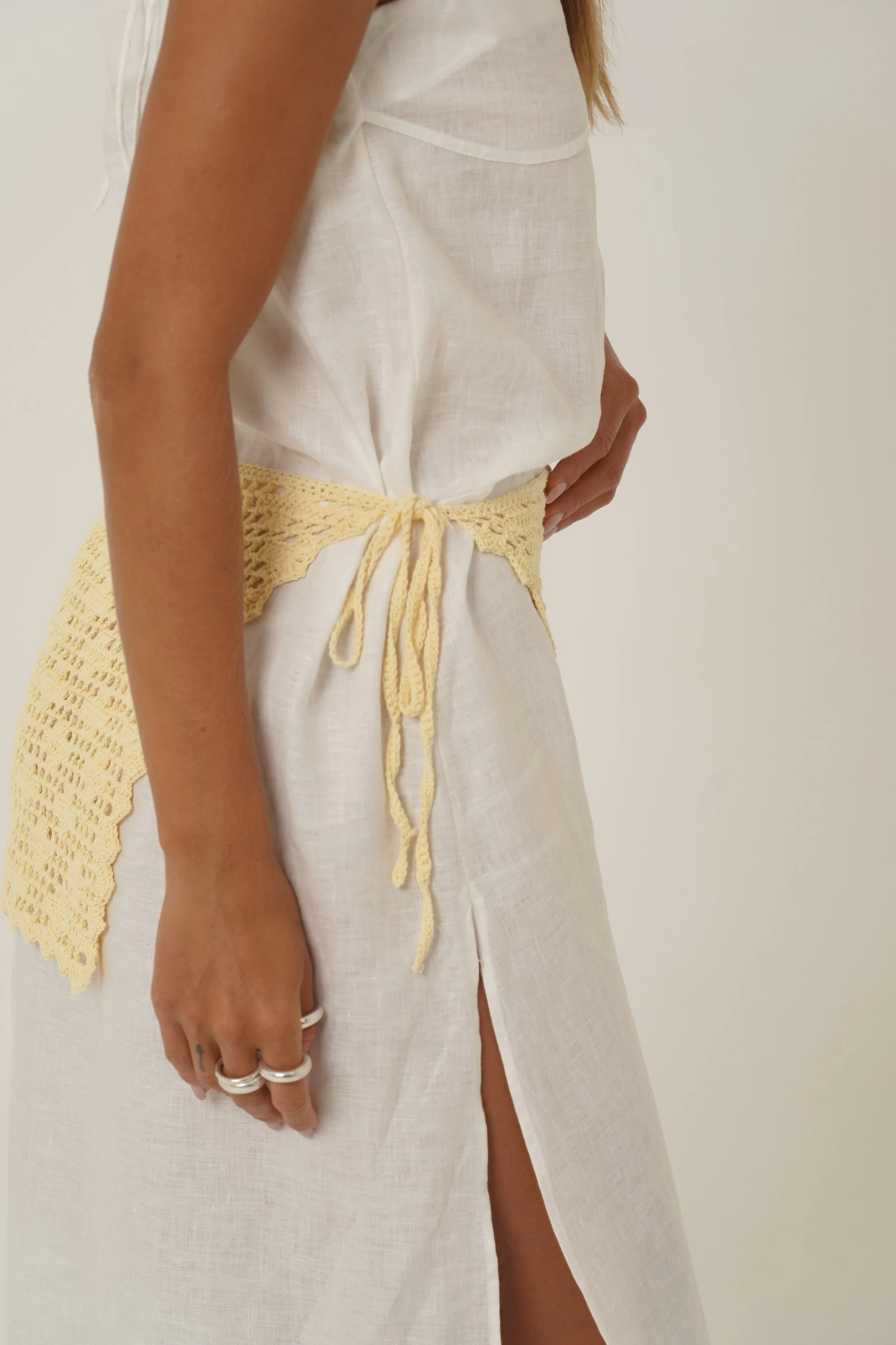 Woman wearing Prélude Maxi Dress in pure linen and Labelle Crochet Sarong detail close up