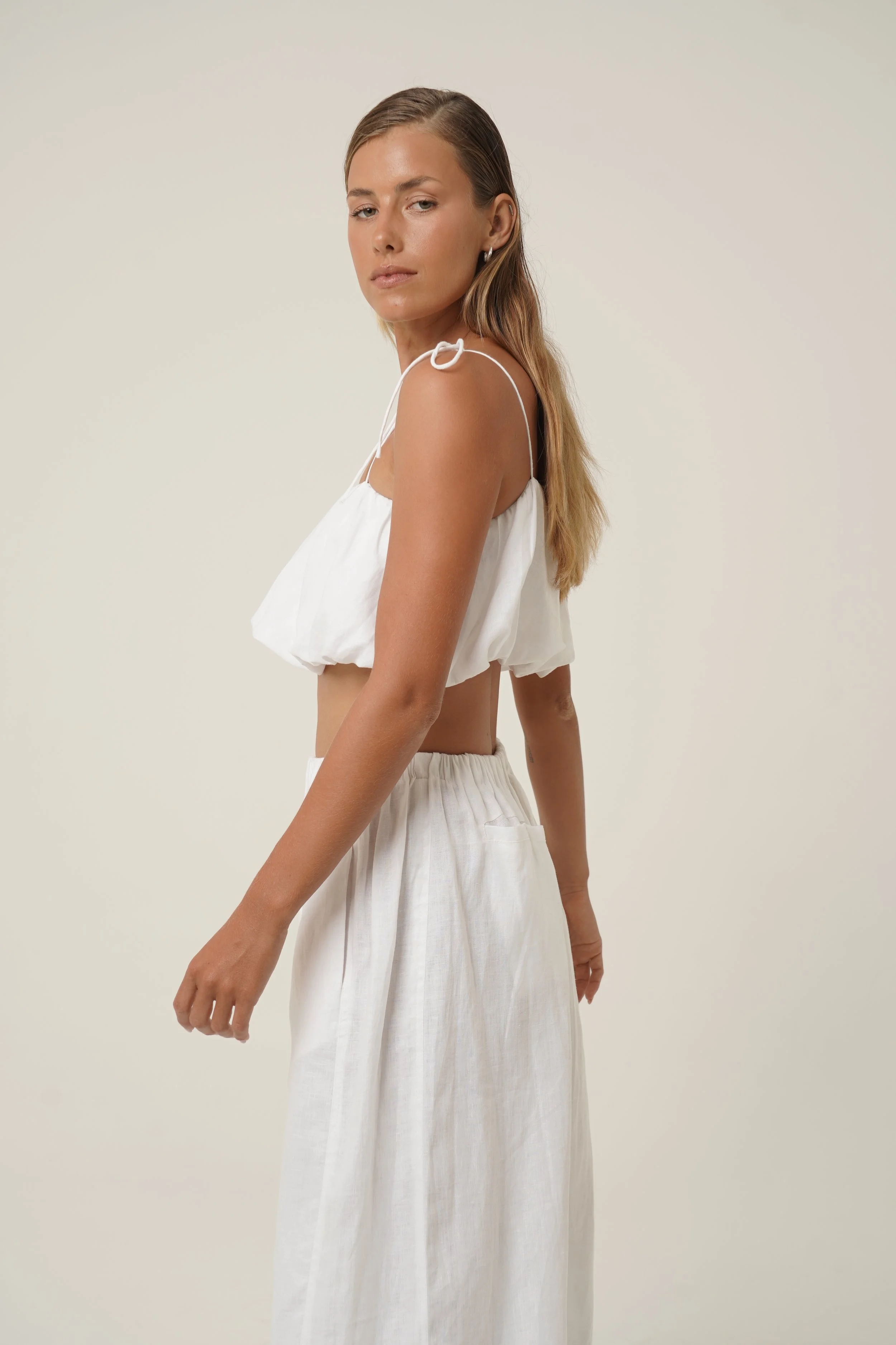 Woman wearing linen Crescendo Top with shoulder straps and double layer