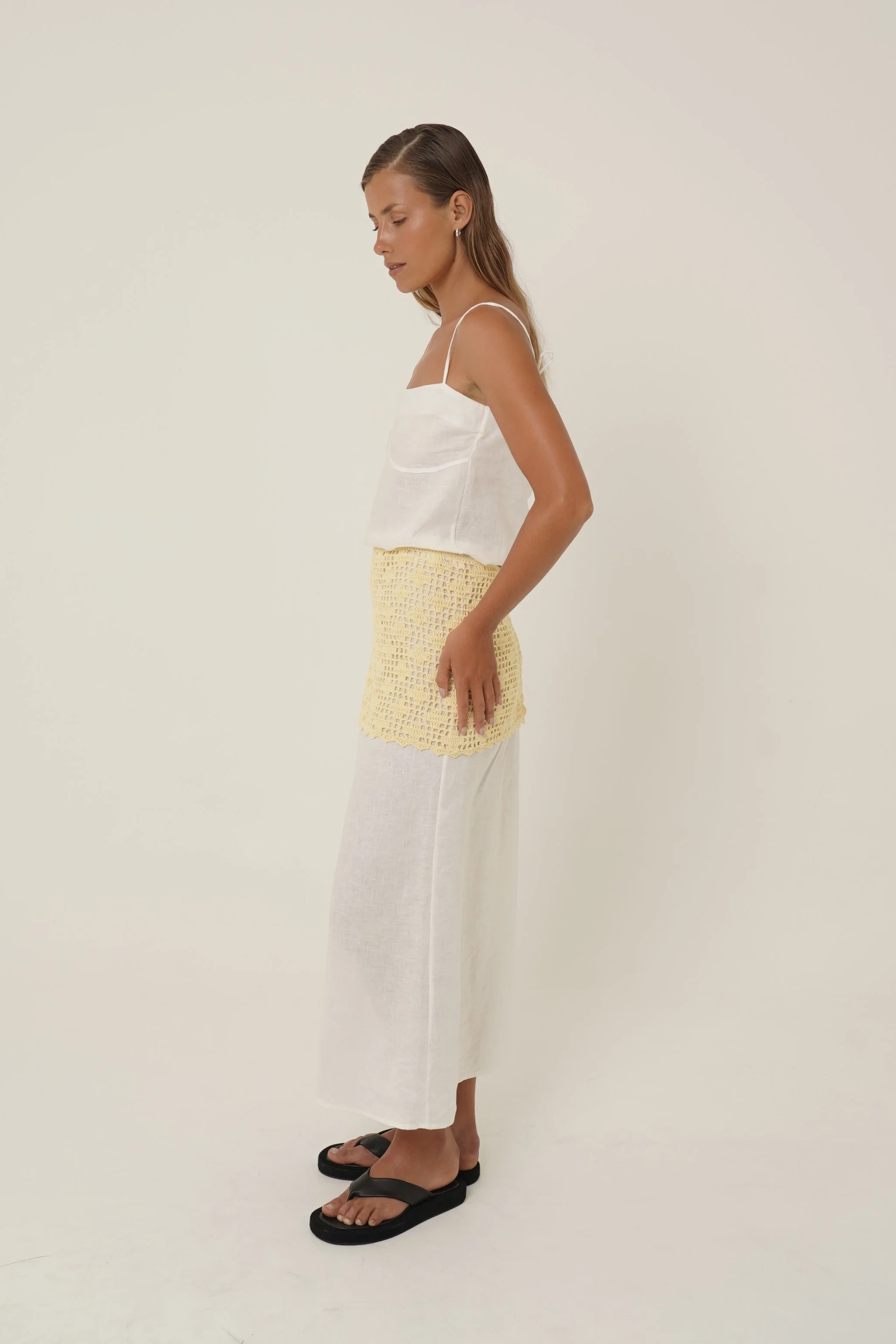 Woman wearing Prélude Maxi Dress in pure linen and Labelle Crochet Sarong side view