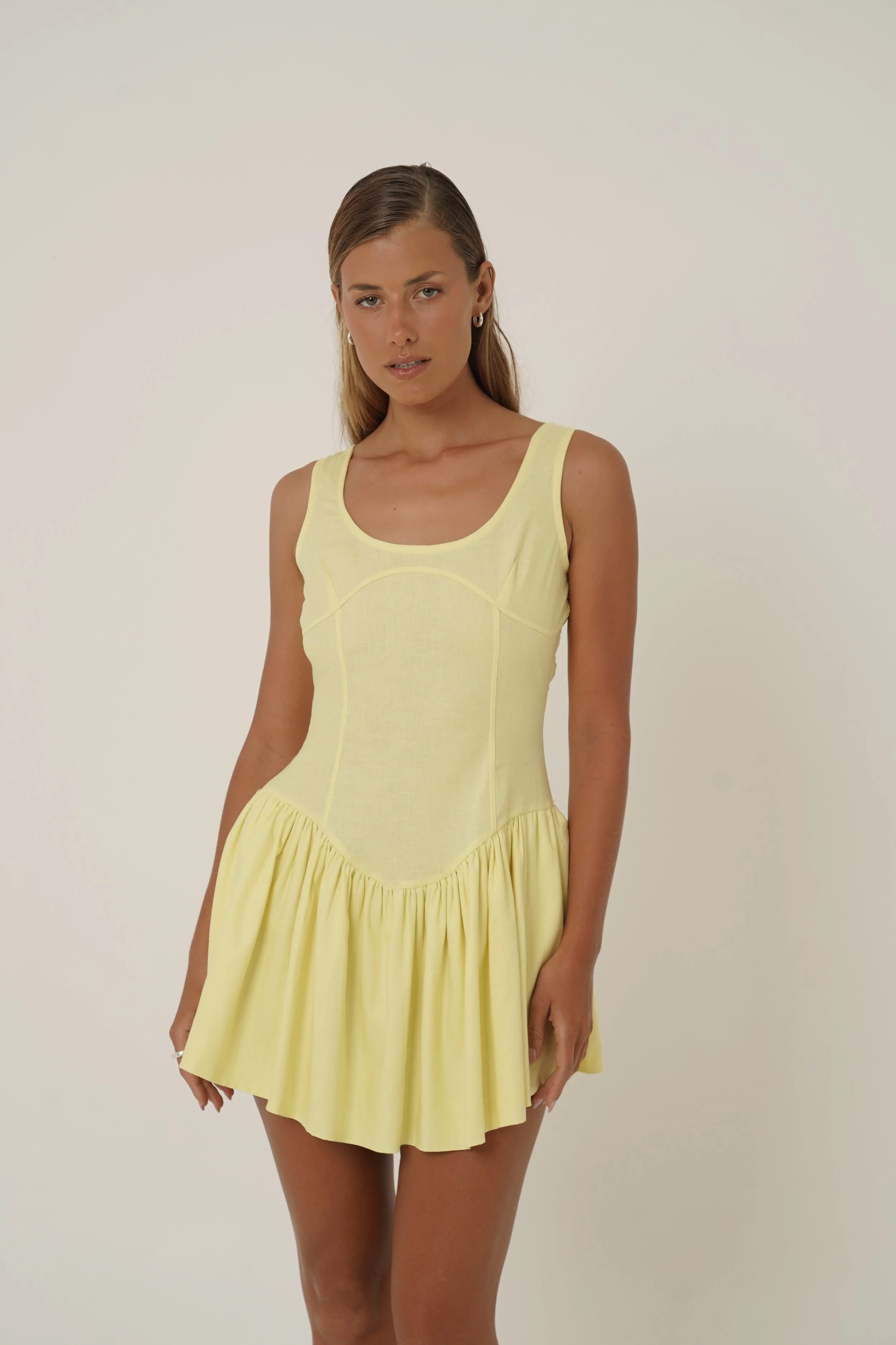 woman wearing prelude yellow mini dress from Sutura Studio