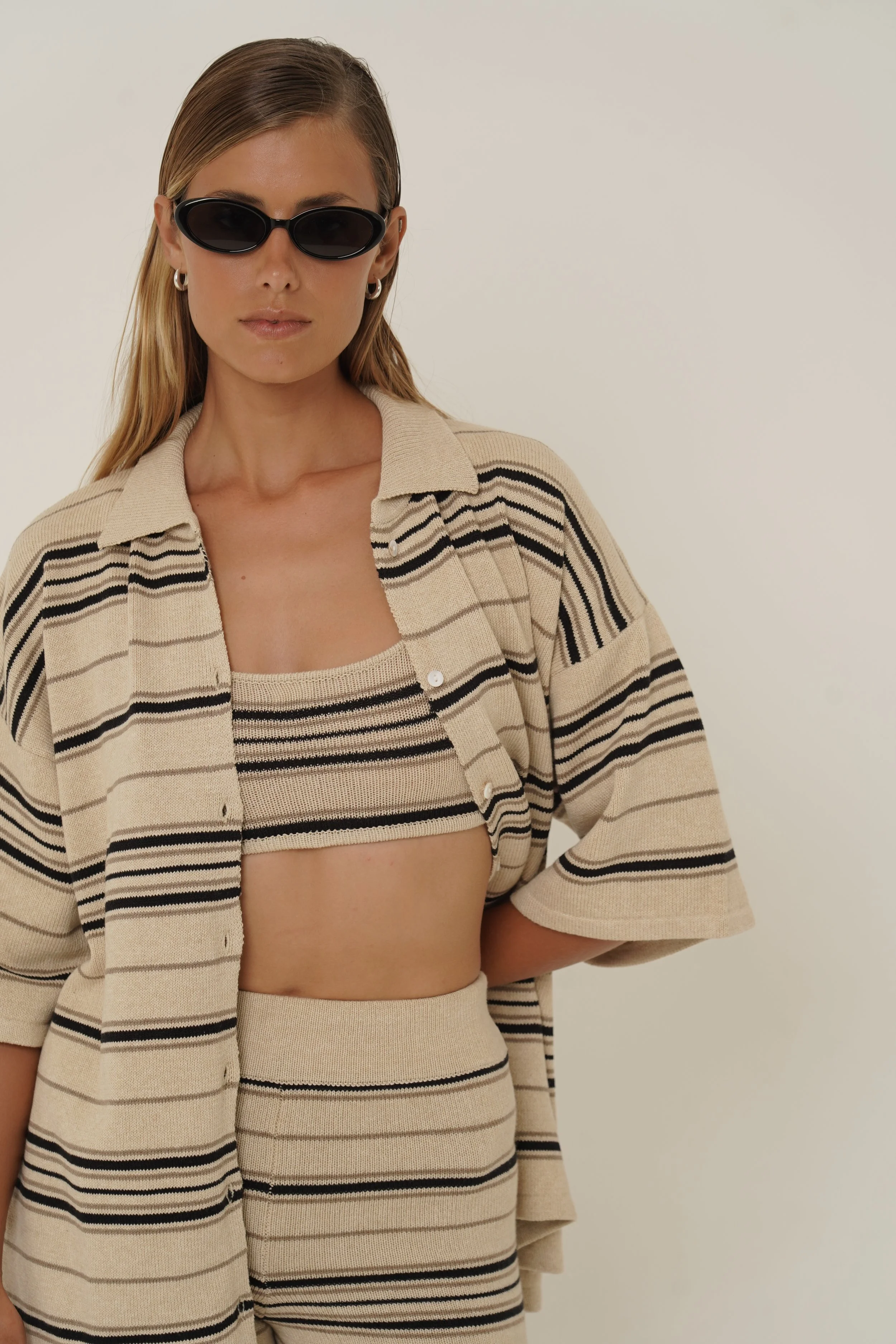Woman wearing Dune Shirt and Top with striped pattern in cotton knit an sunglasses
