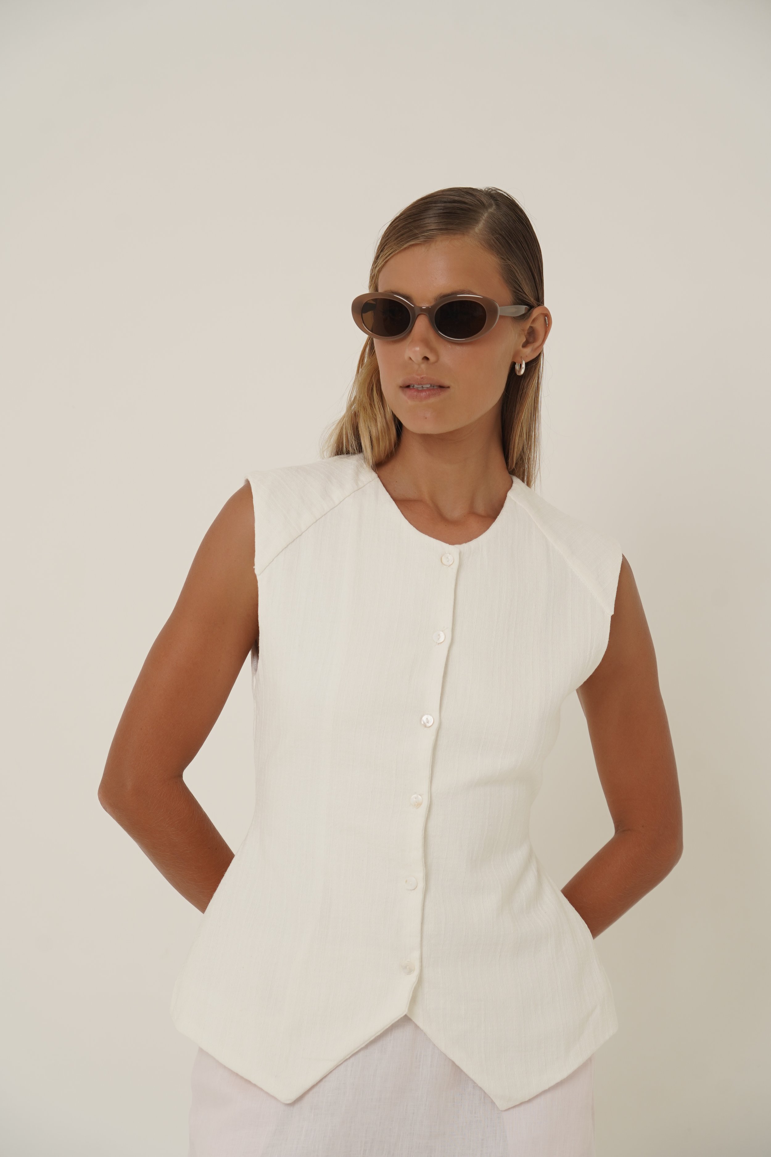 Woman wearing Basmati Vest front view wearing sunglasses