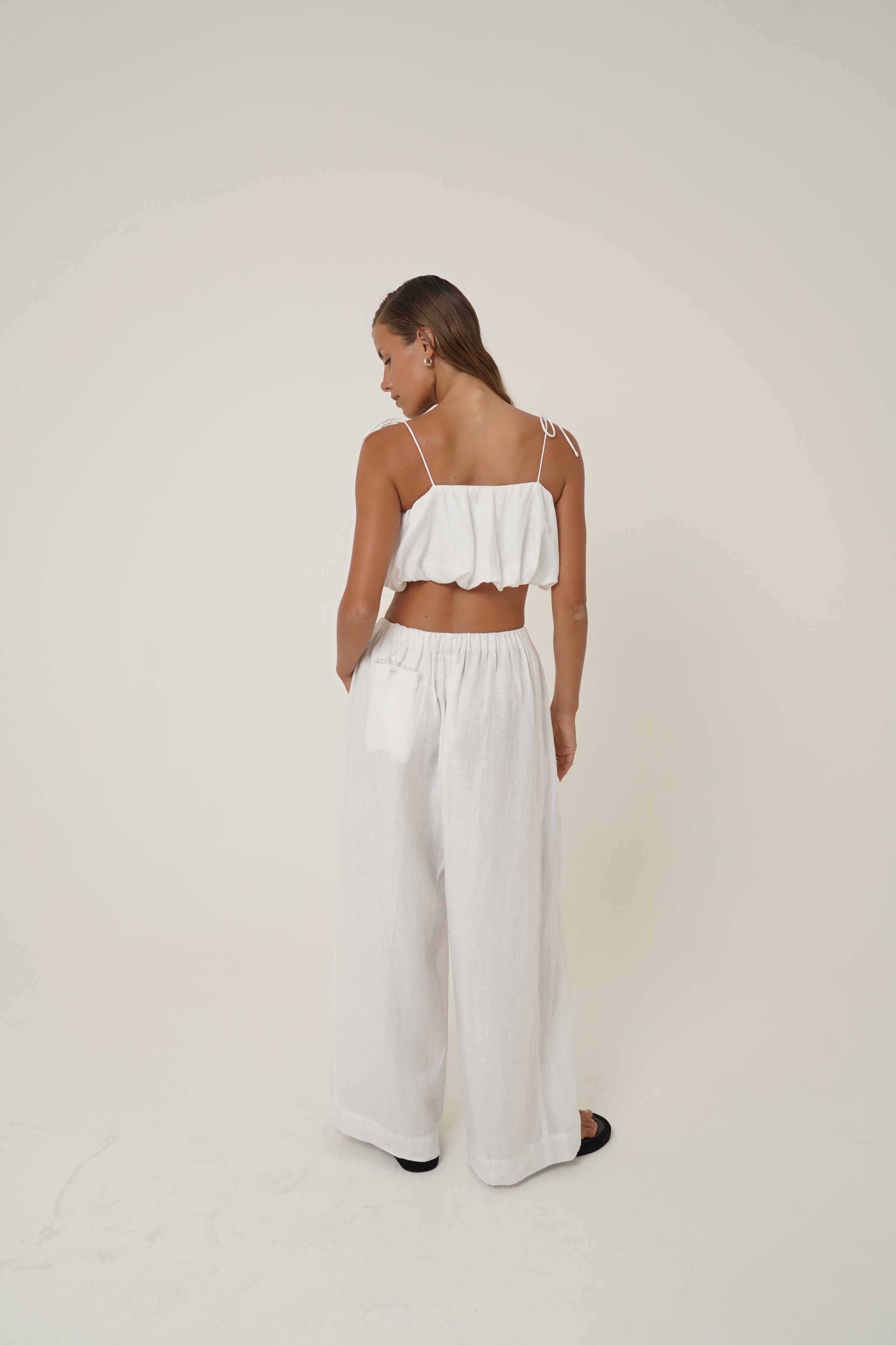 Woman wearing linen Crescendo Top with shoulder straps and double layer
