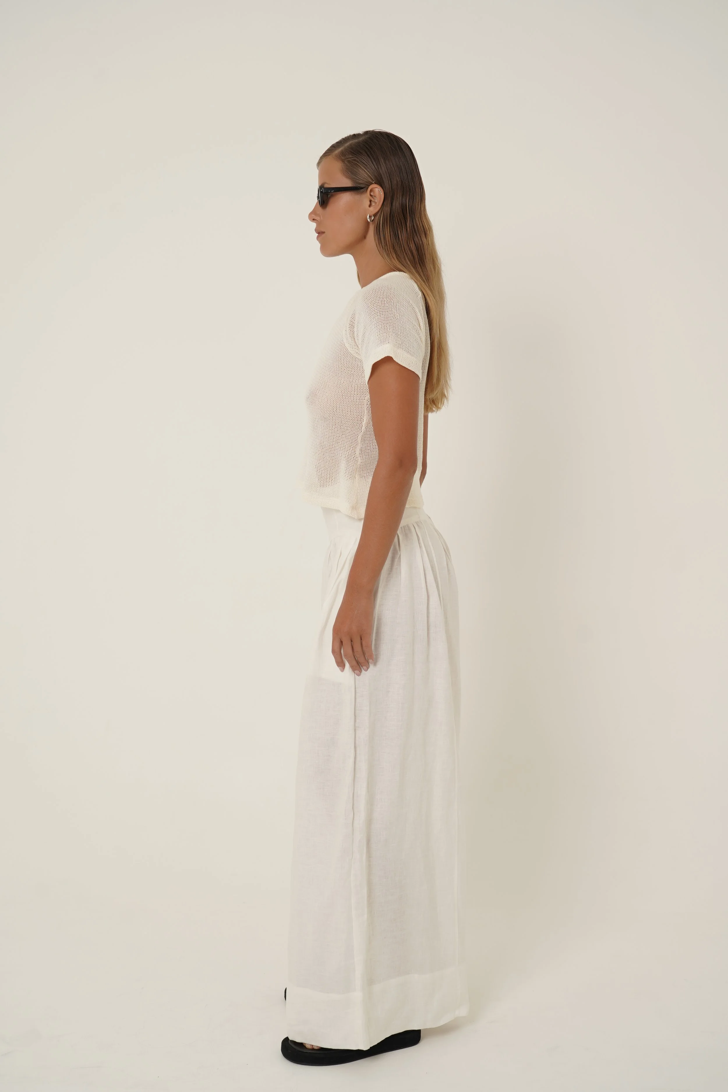 Woman wearing linen Cassandra Pants and Breeze Cotton Mesh T-shirt
