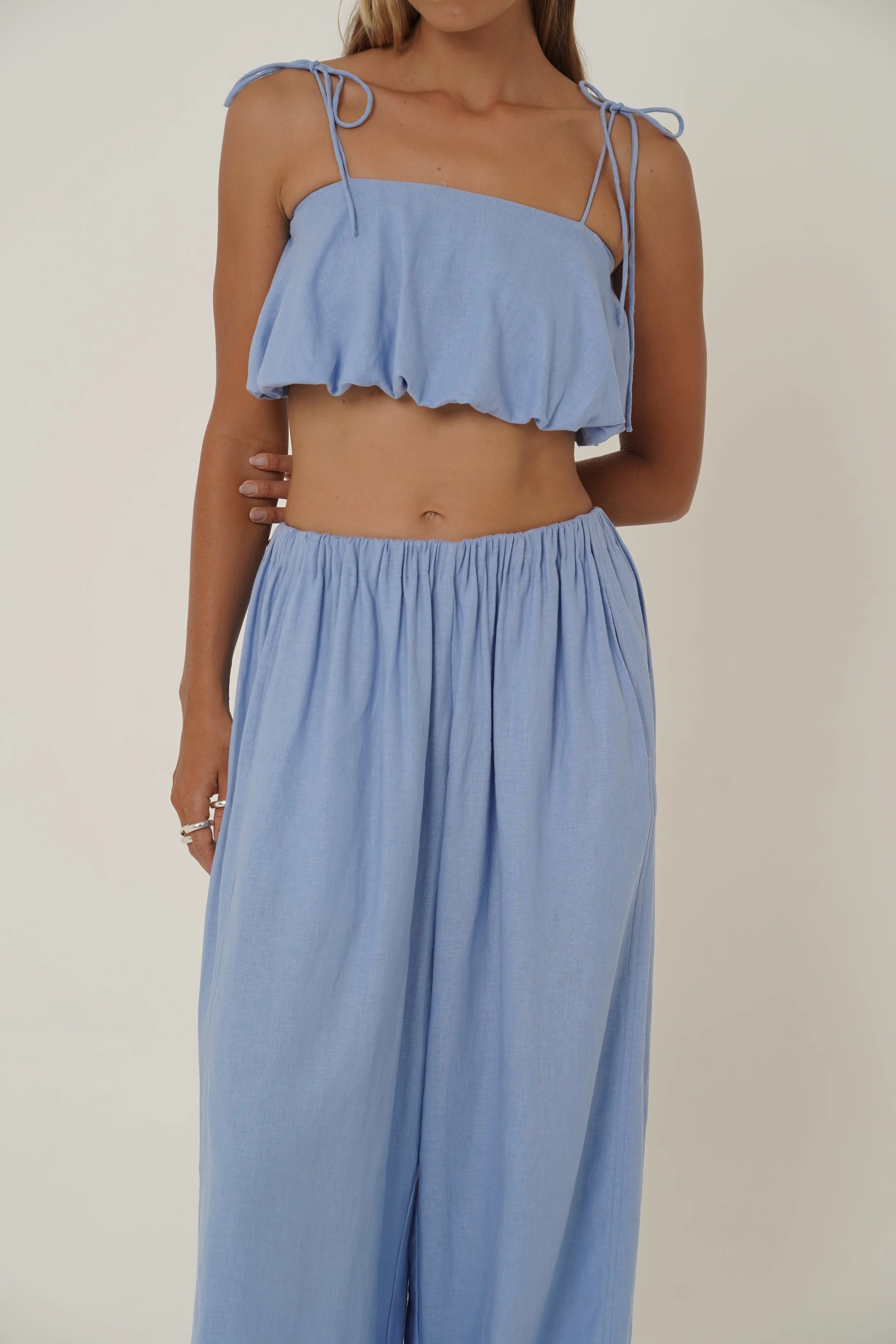 Woman wearing linen Crescendo Pants and Top with elastic waist and french seam