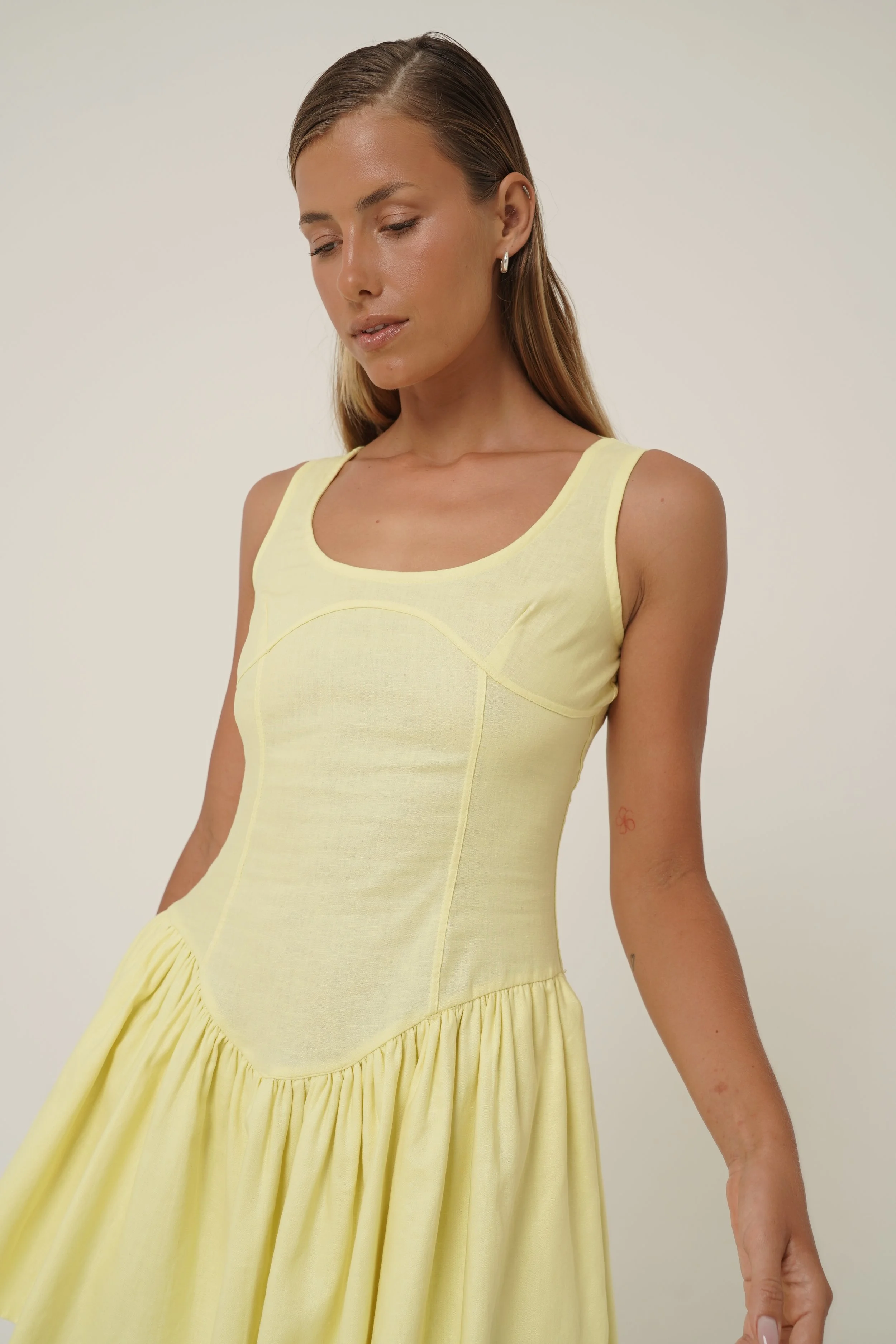 woman wearing prelude yellow mini dress from Sutura Studio