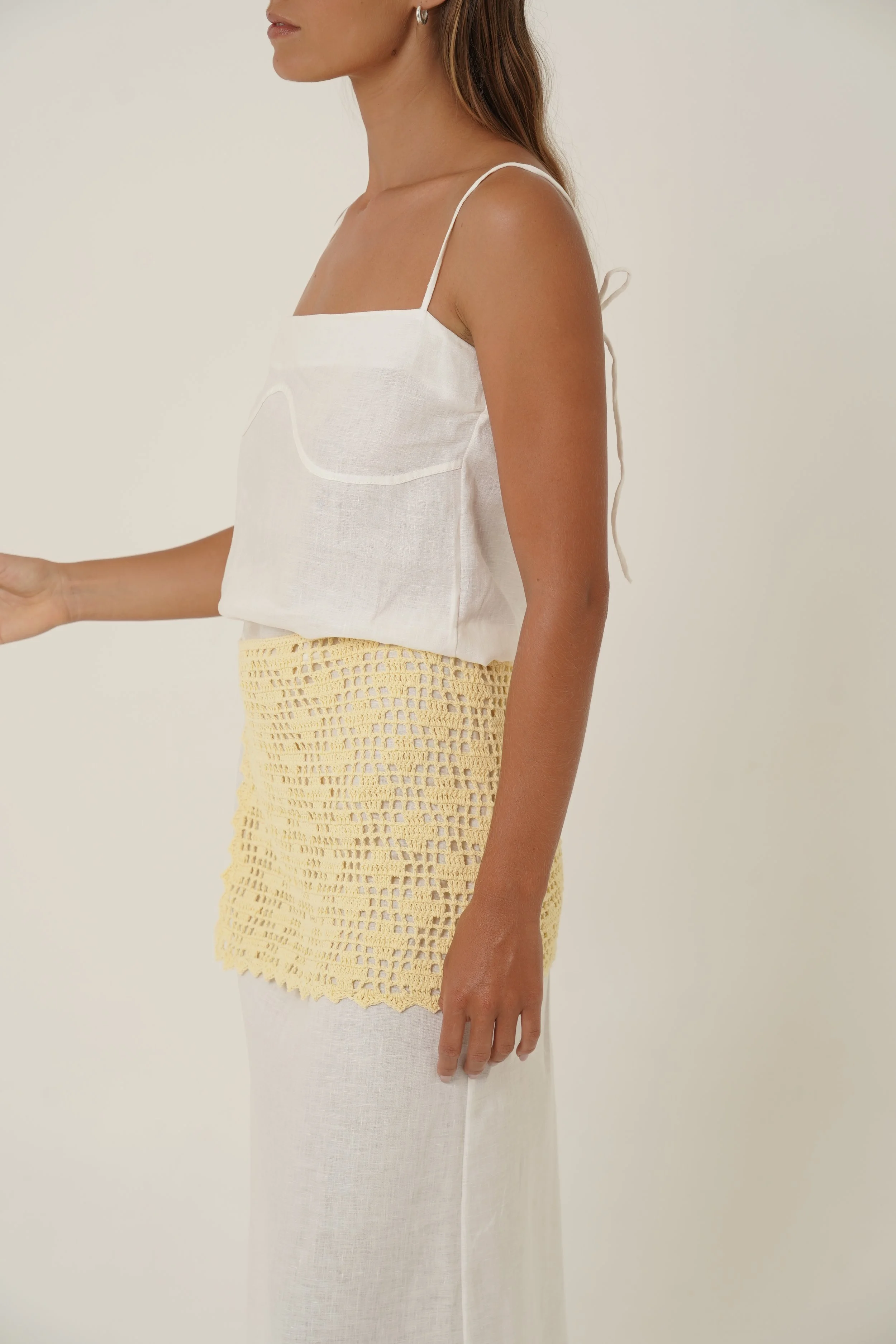 Woman wearing Prélude Maxi Dress in pure linen and Labelle Crochet Sarong side view