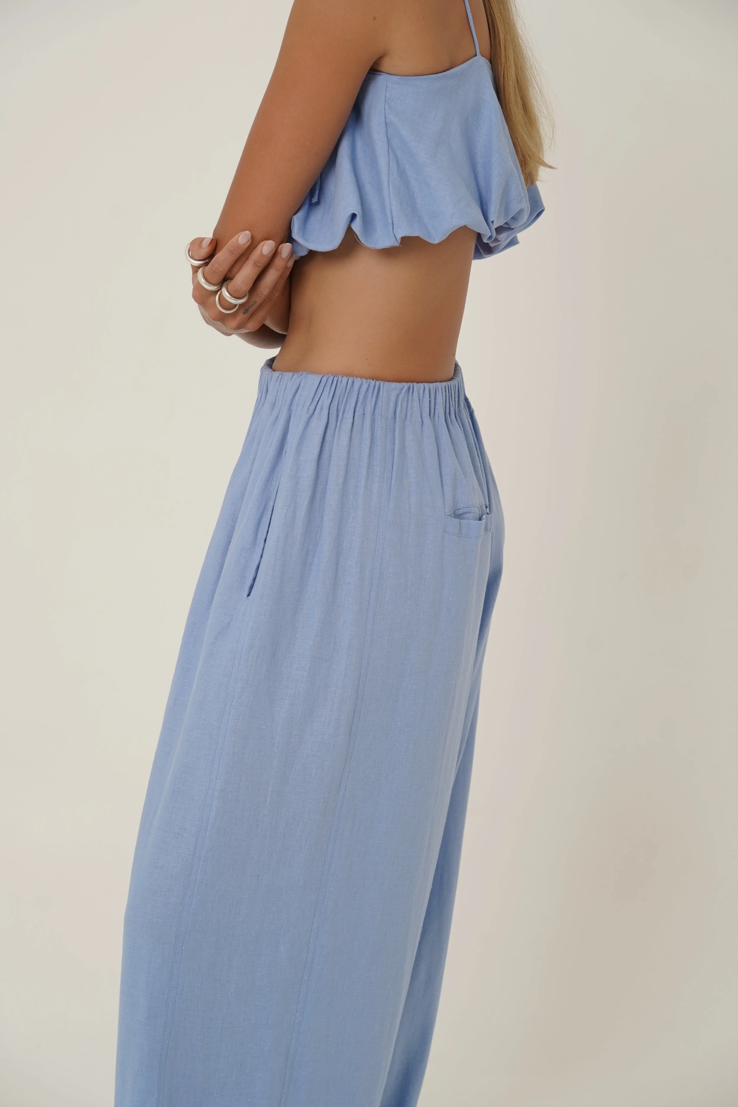 Side view of woman wearing linen Crescendo Pants and Top with elastic waist and french seam