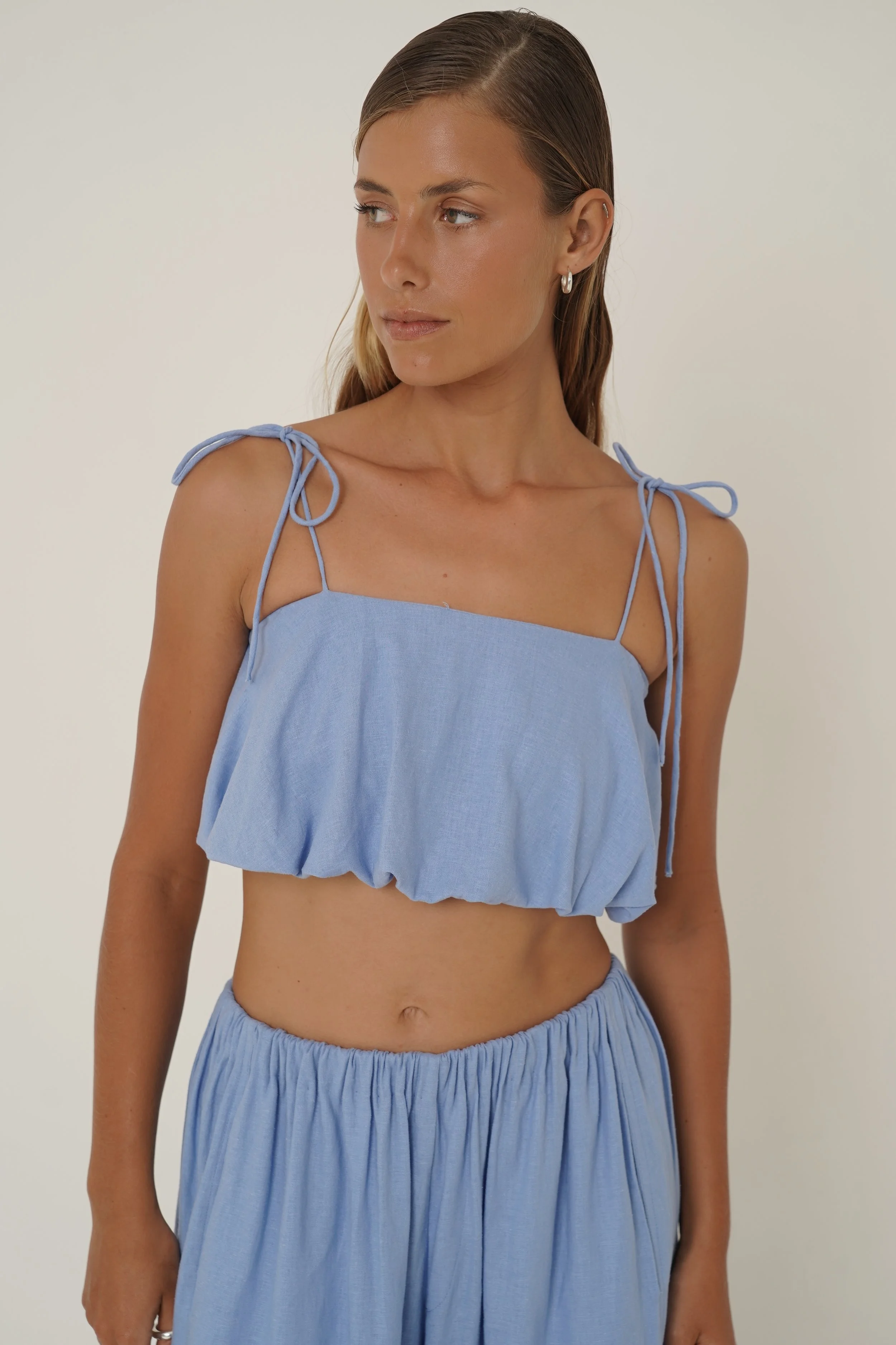 Woman wearing linen Crescendo Top with shoulder straps and double layer