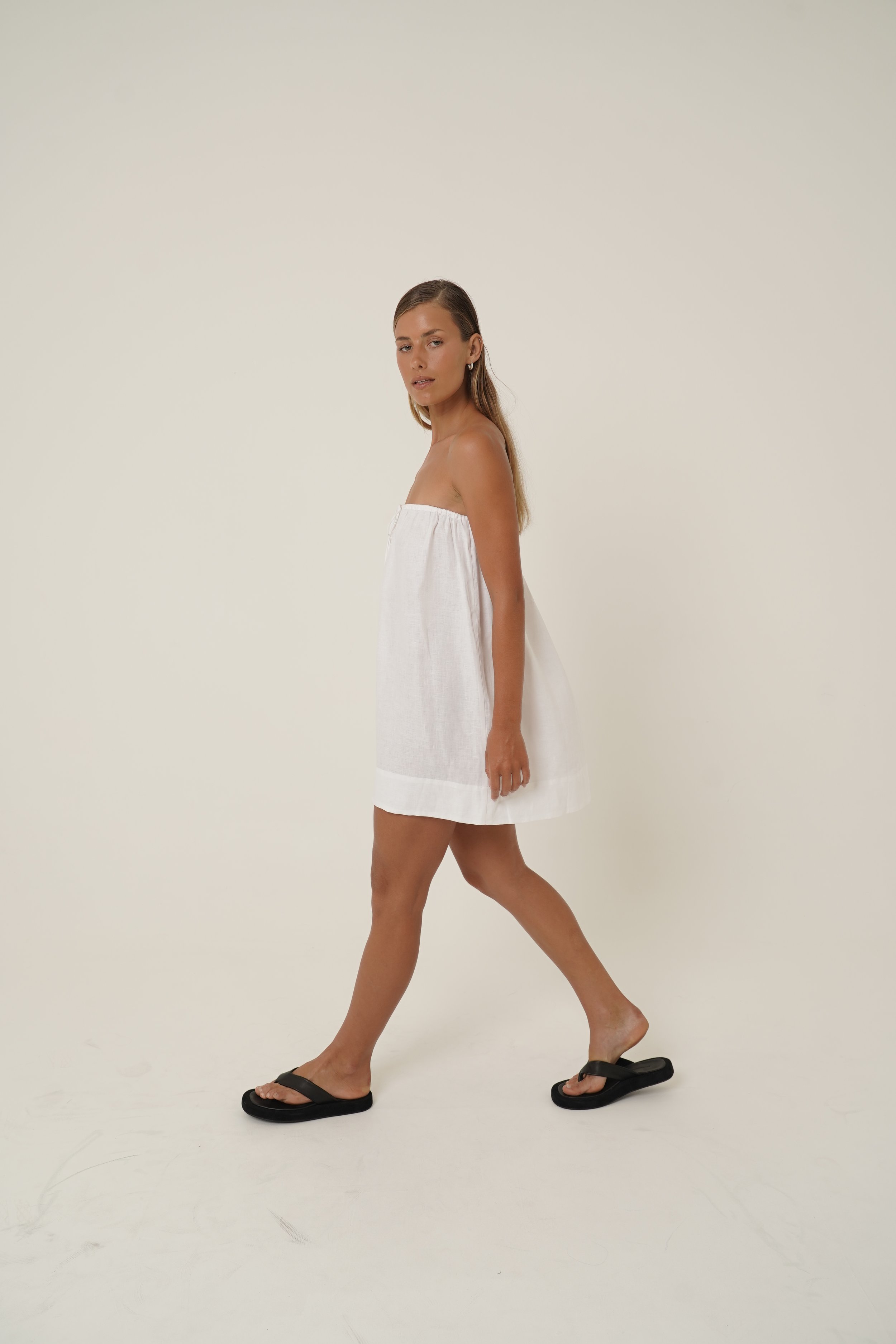 Woman wearing Reverie Dress in pure linen side view