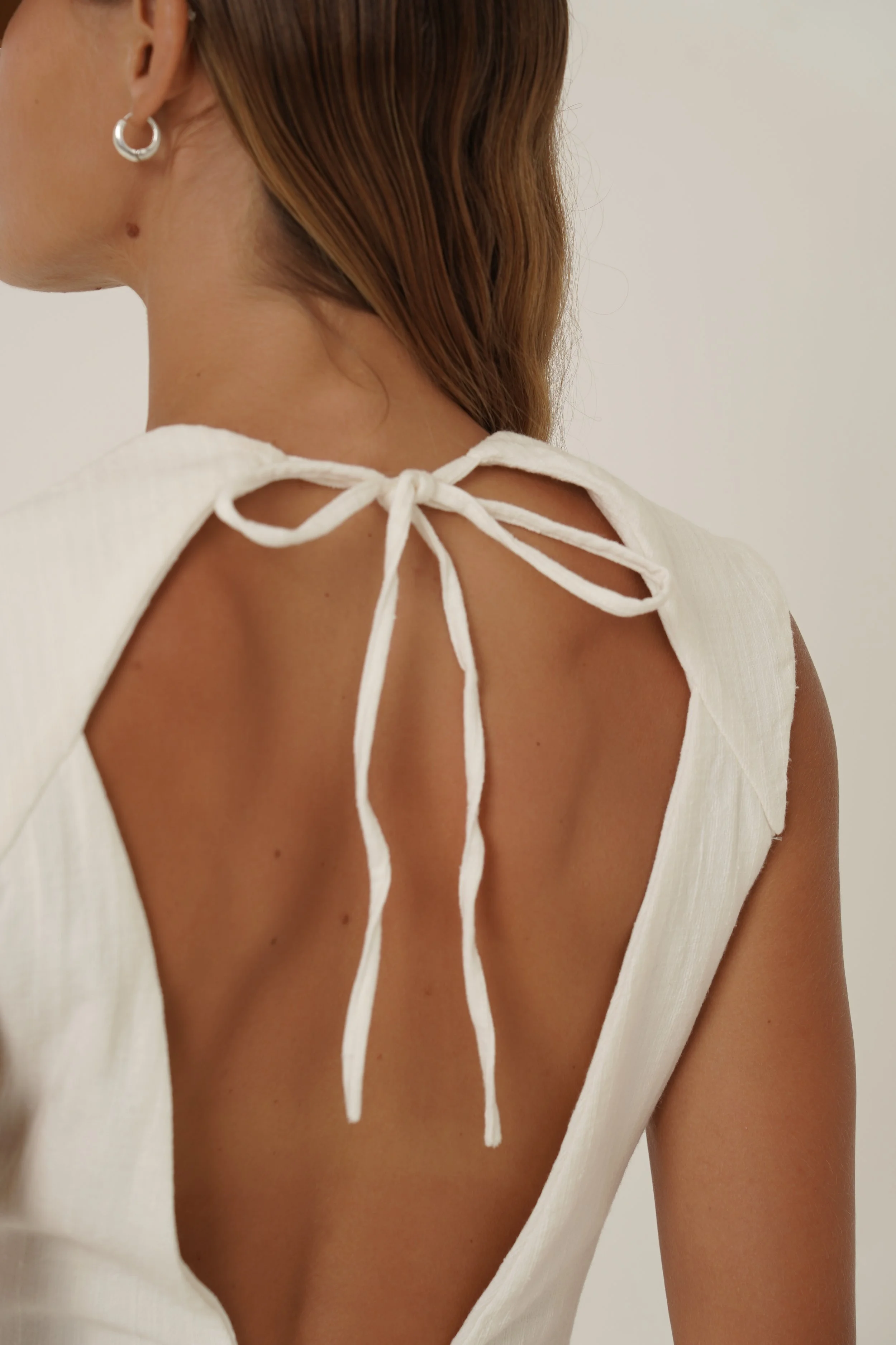 Woman wearing Basmati Vest back view with strap detail close up