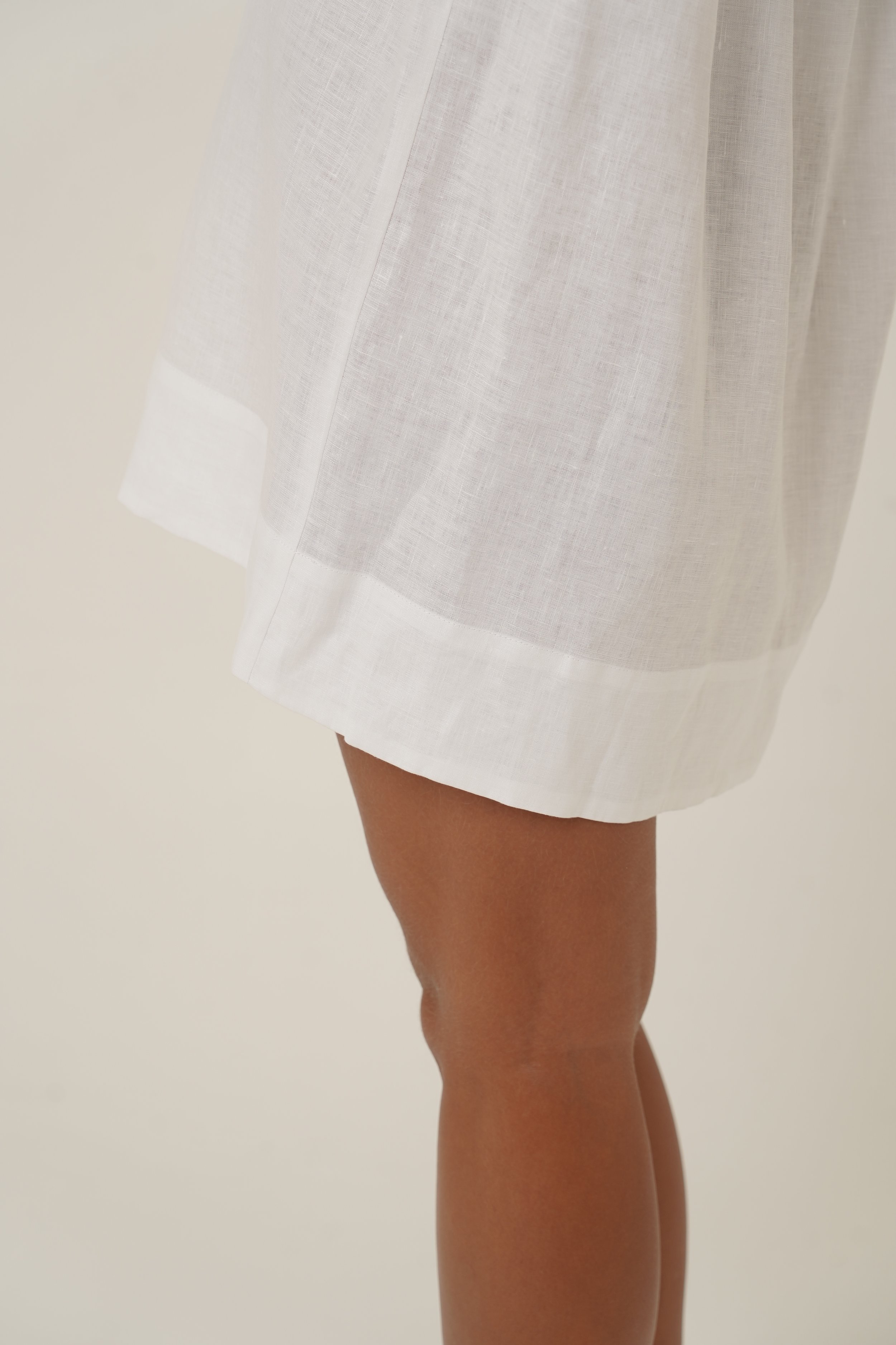 Woman wearing Reverie Dress in pure linen hem detail