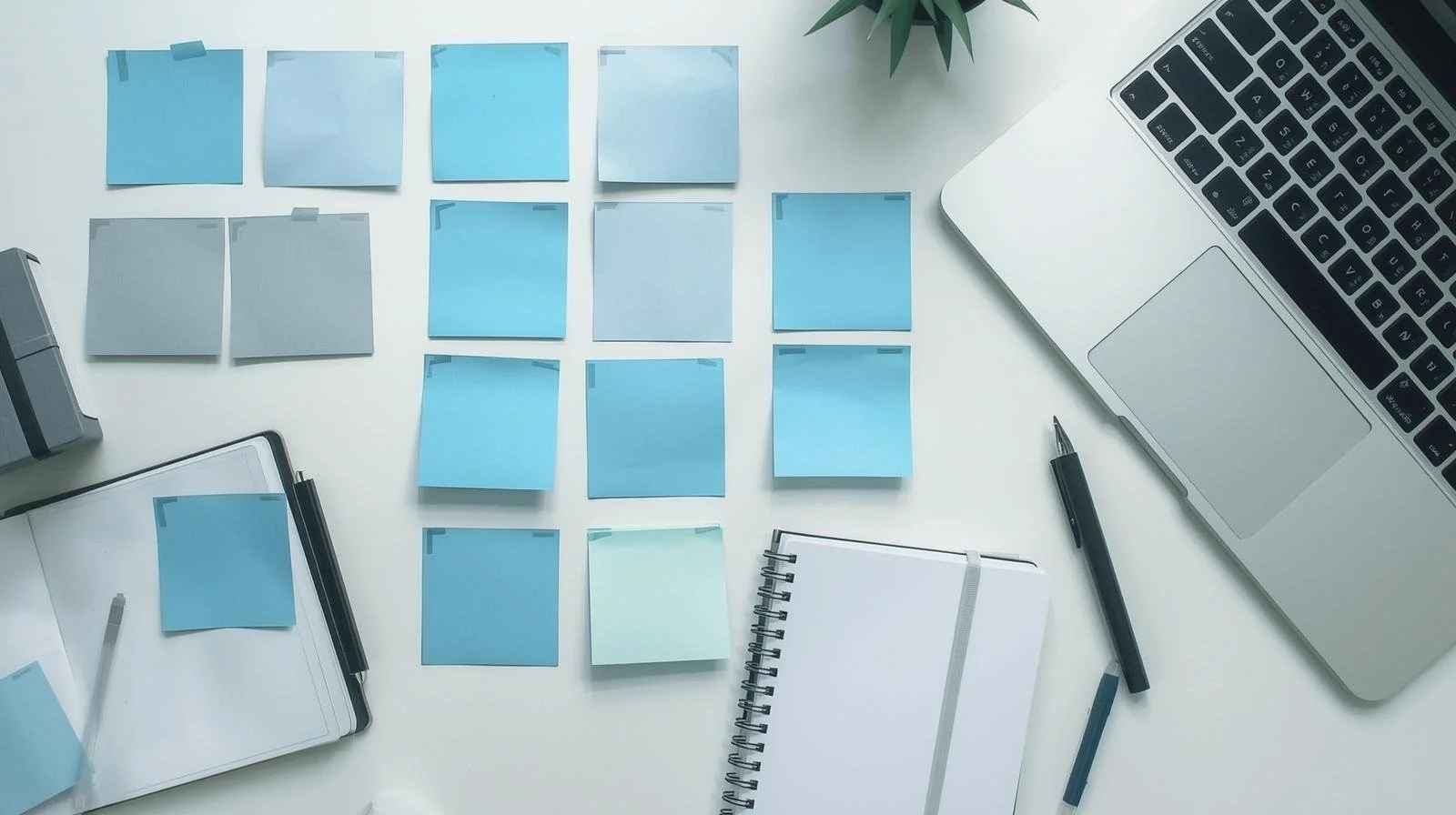 Overhead shot of creative planning and strategising for marketing  using colourful sticky notes, and laptop
