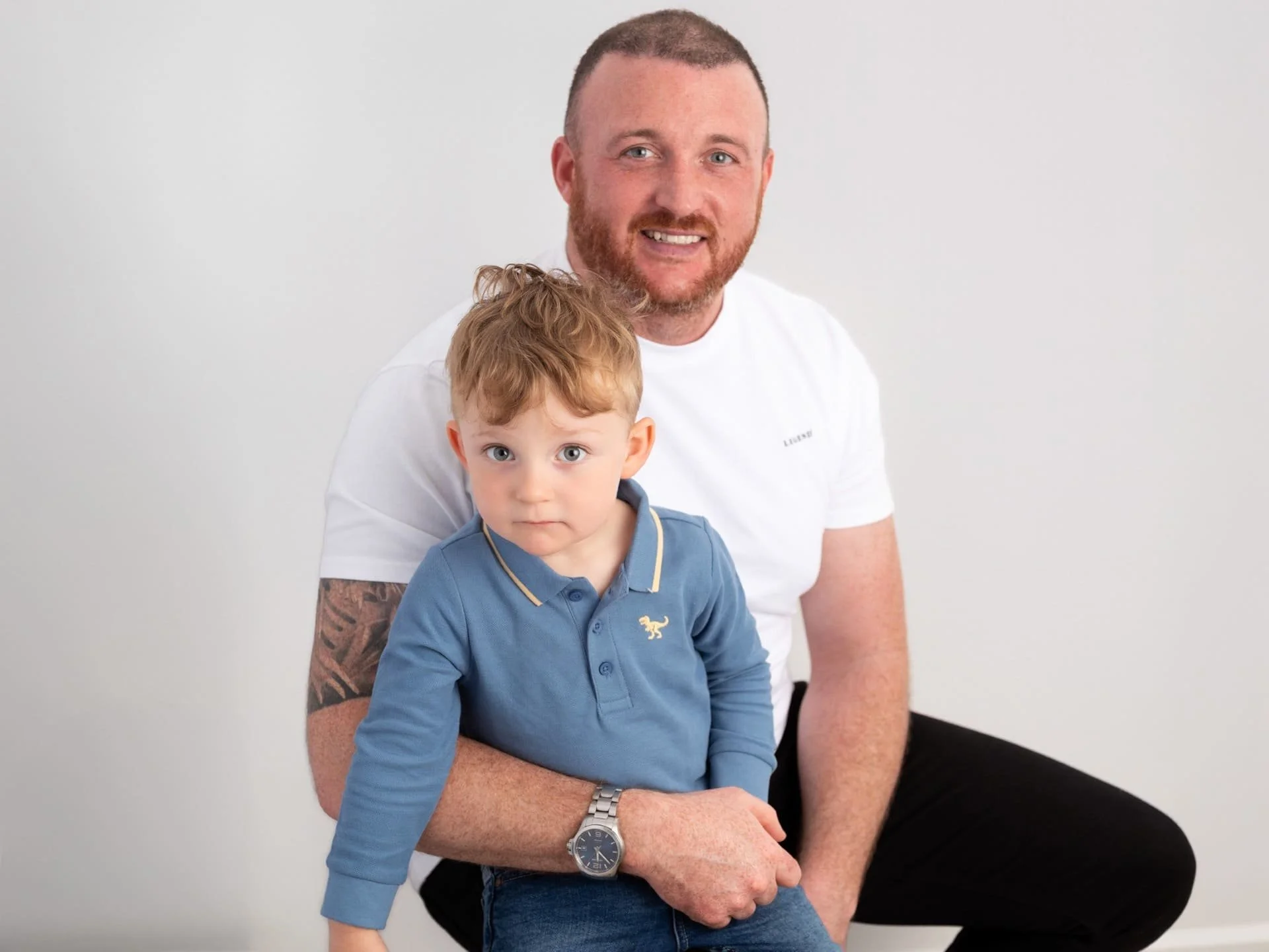 A father and son sitting with each other