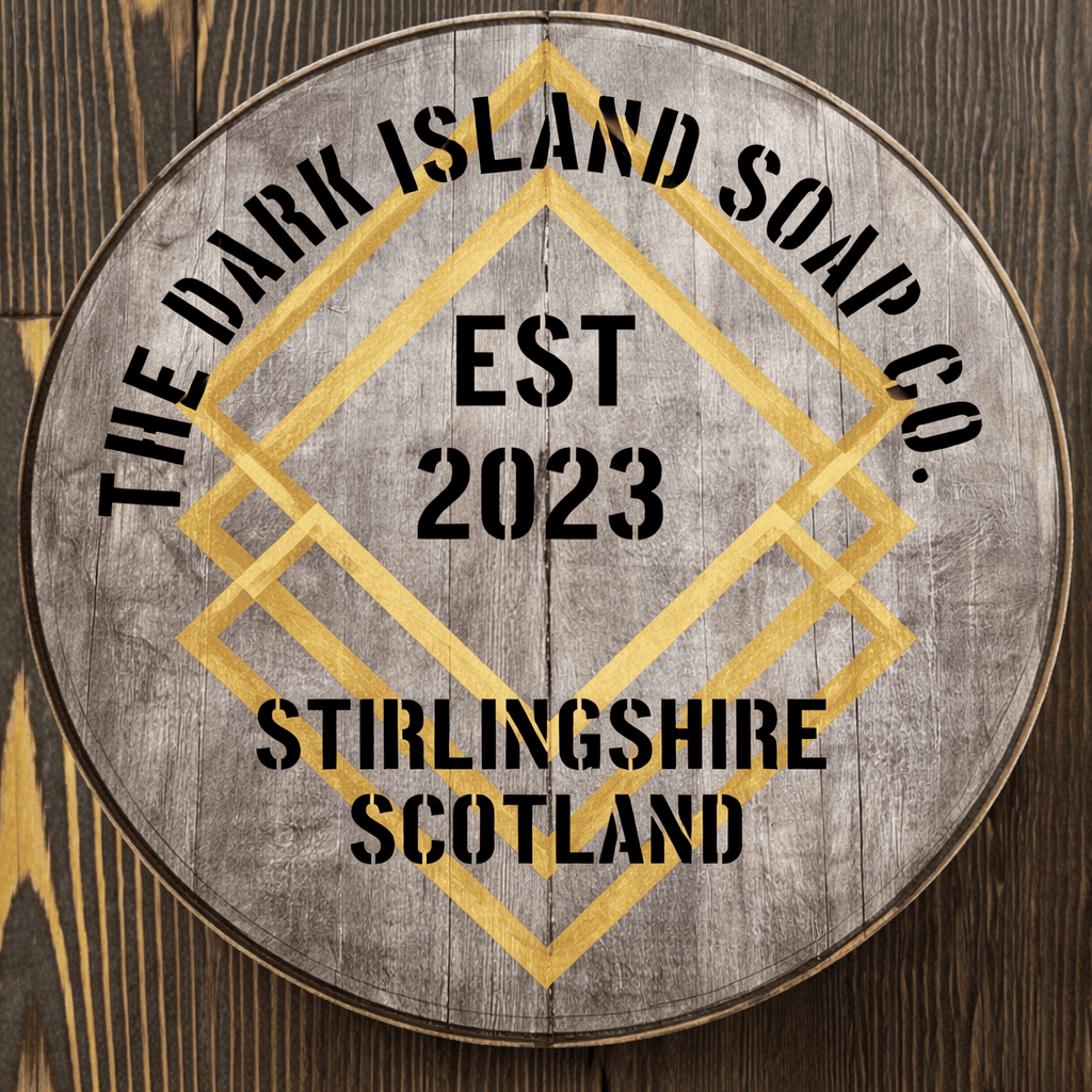 Wooden circular sign with black and gold lettering that reads 'The Daring Island Soap Co. EST 2023 Stirlingshire Scotland,' featuring geometric gold decorative lines.