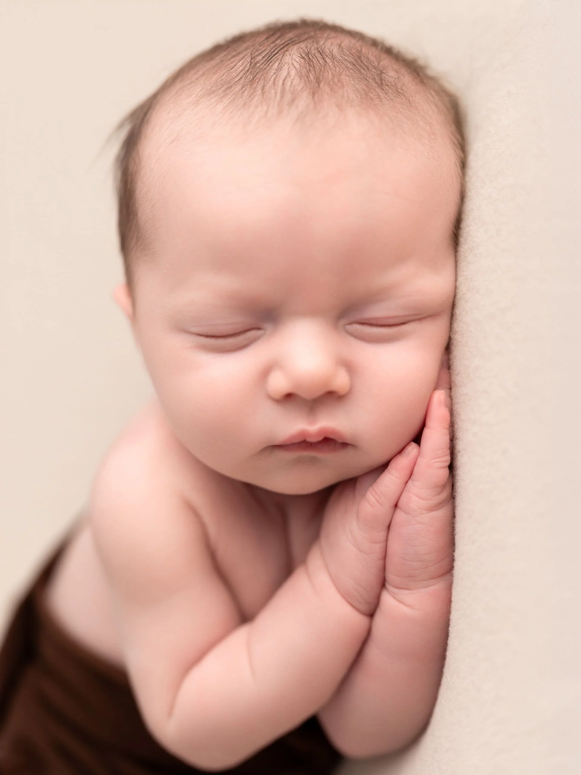 A baby laying on it's side fast asleep
