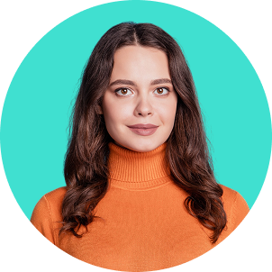 A woman with long dark hair wearing an orange turtleneck sweater, smiling with a teal background.