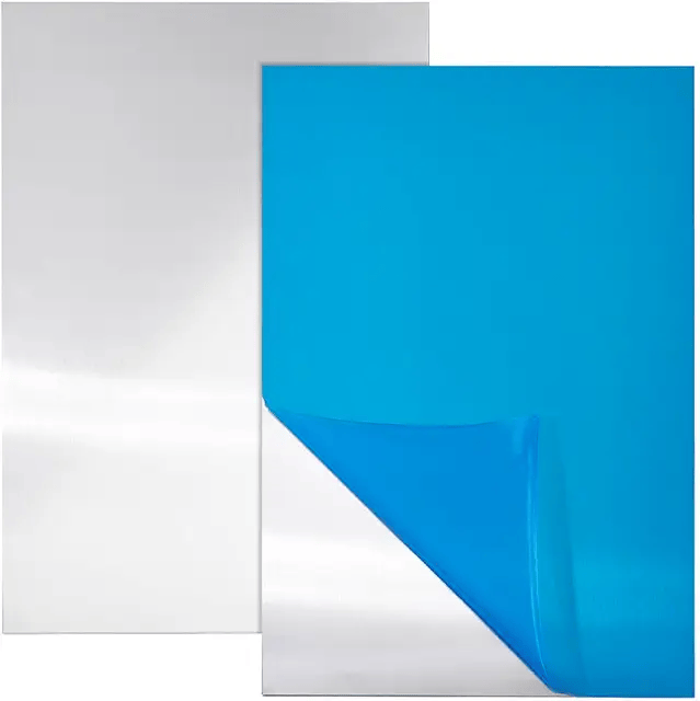 A close-up of a white and blue paper or card stock with a folded corner, showing the blue side as the inner layer.