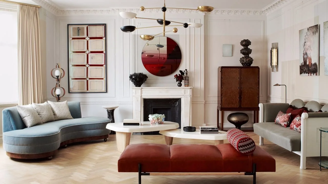Living room with panelled walls, marble fireplace and herringbone floor in a Kennington period home