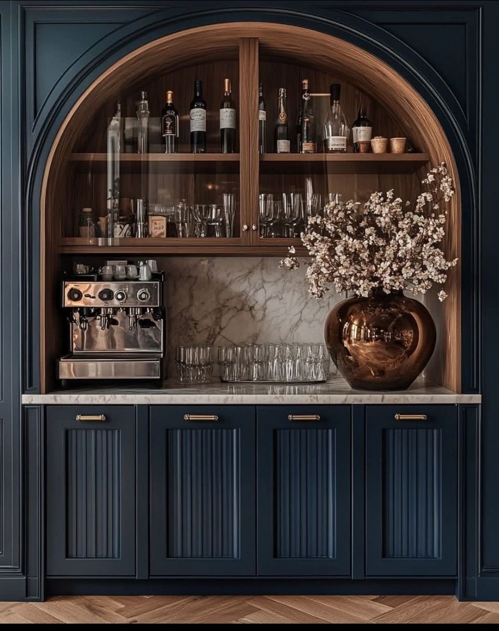 Bespoke navy drinks cabinet with arched wood shelving, espresso machine and brass hardware