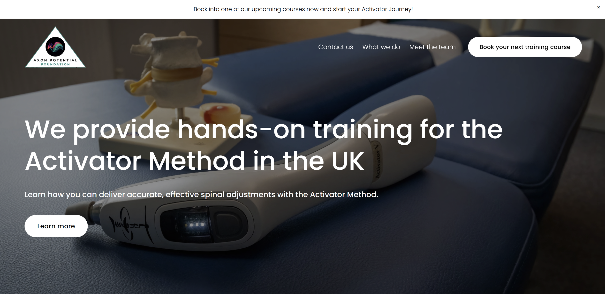 Homepage of Axon Potential Foundation website featuring a spinal adjustment device and a model of a spine, with navigation links and call-to-action buttons for booking courses and learning more.