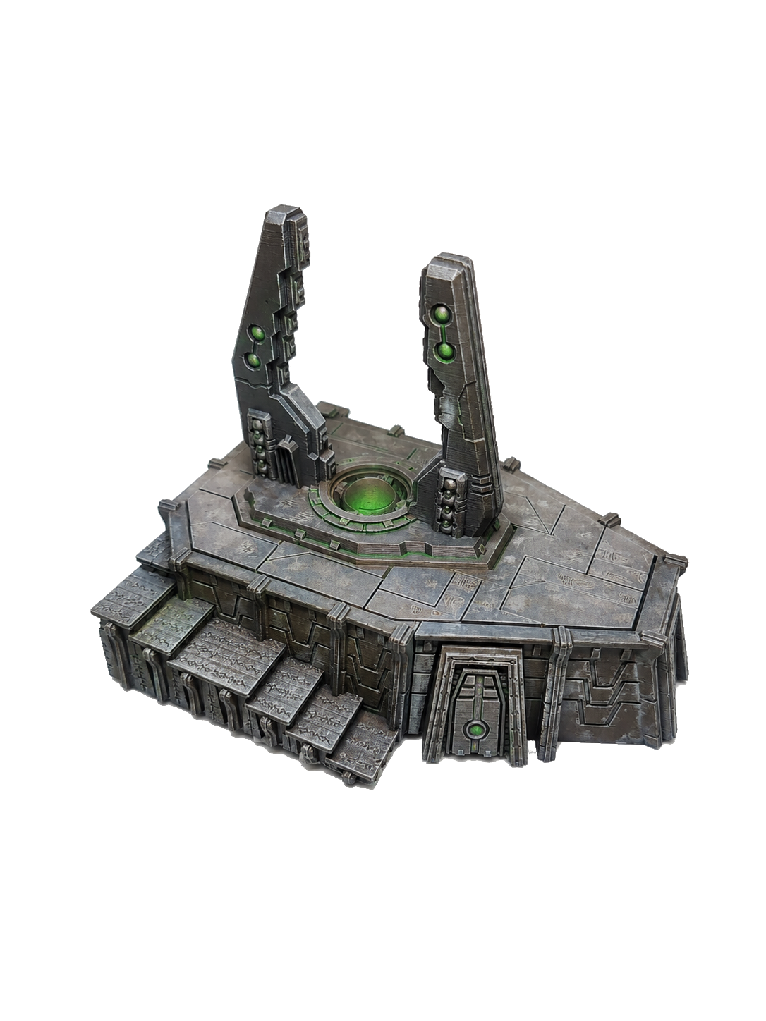 A futuristic, metallic structure with a central green light and two tall, vertical panels with green lights, resembling a sci-fi portal or device.