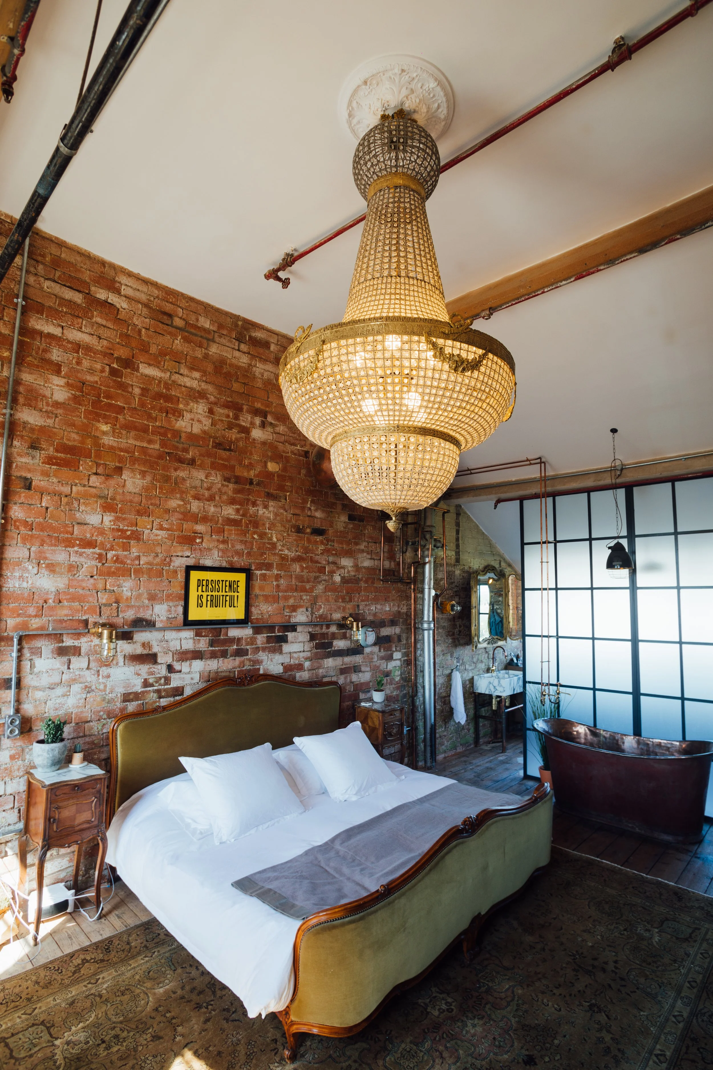 The grandest chandelier hangs over the emperor bed