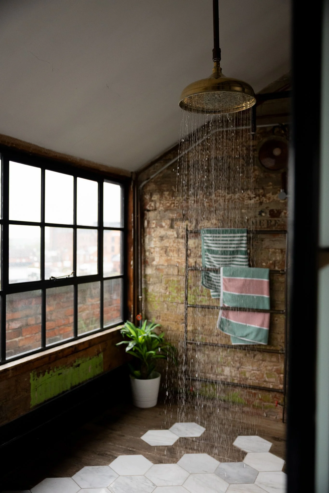 A private, walk-in rainfall shower in the master bedroom
