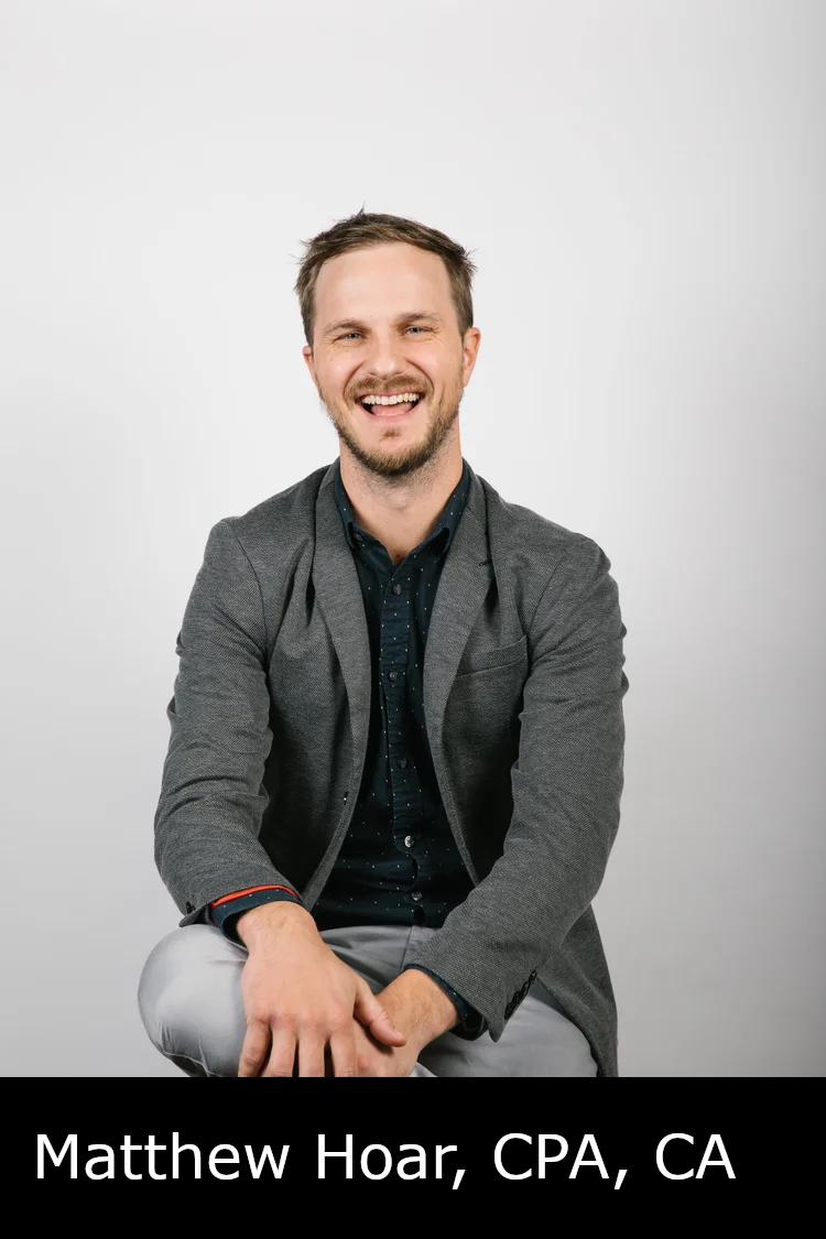 A man with short brown hair and a beard, smiling and sitting against a plain white background, dressed in a gray blazer and dark shirt. Caption: Matthew Hoar, CPA, CA.