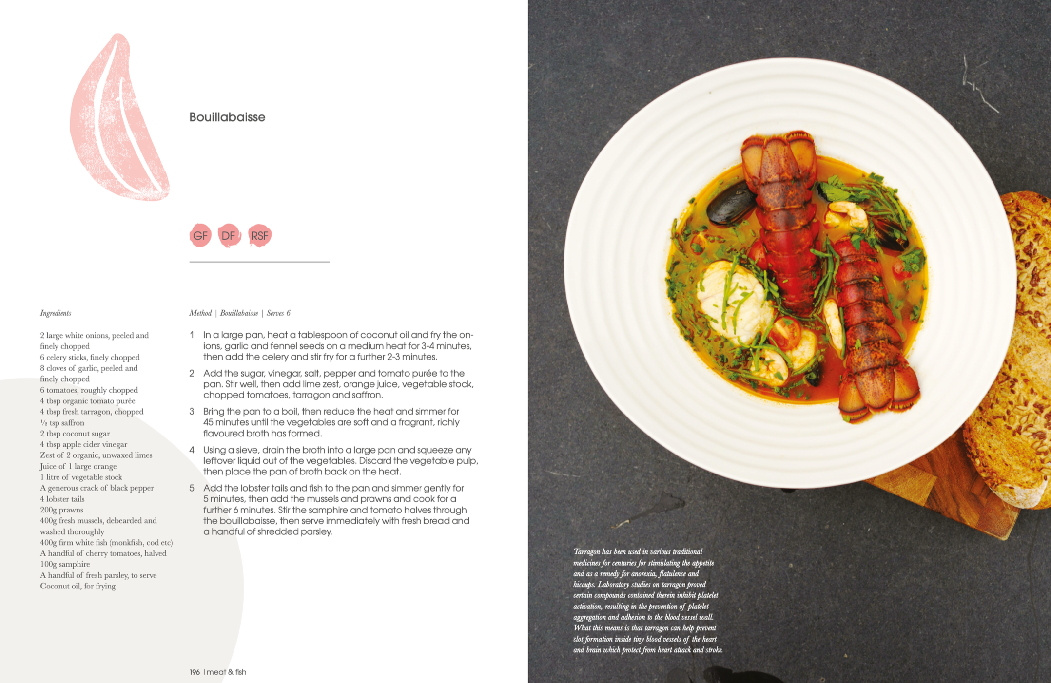 A plate of seafood soup with lobster tails, shrimp, mussels, and herbs in a yellow broth, served with a slice of bread, on a dark surface.