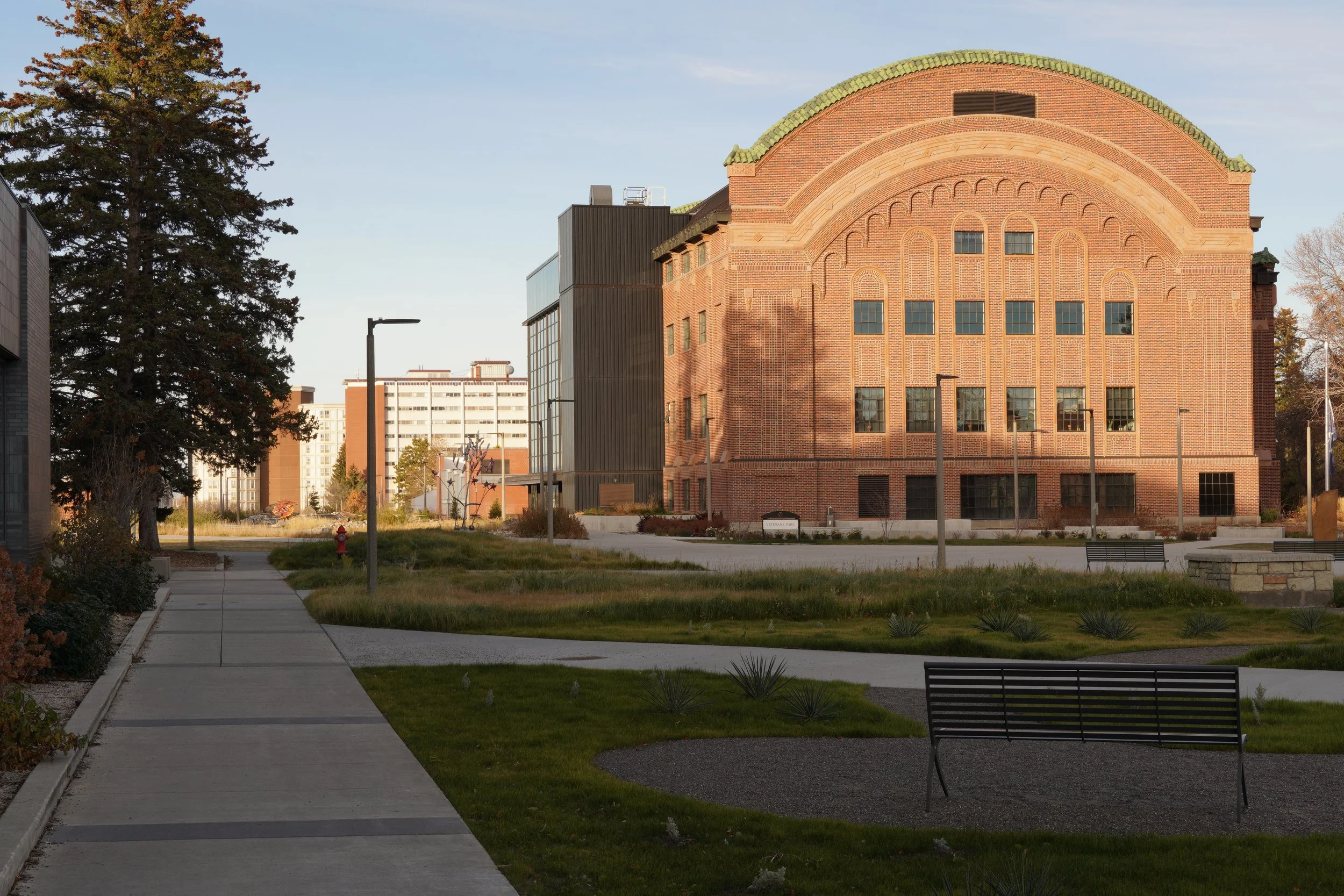 Grant Street transformation to pedestrian mall integrating with modern addition and adaptive reuse of Romney Hall demonstrating campus planning expertise.