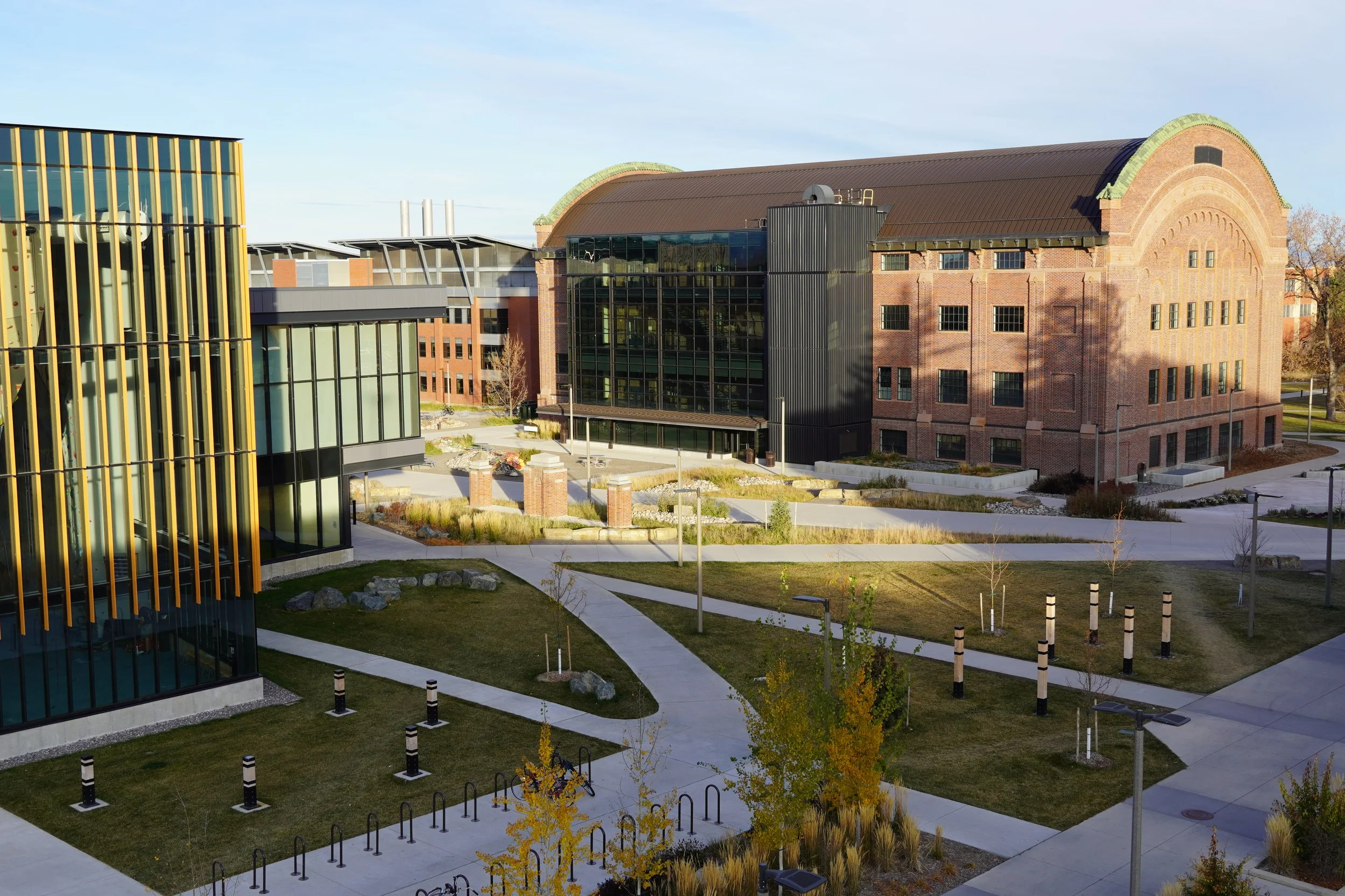Master planned plaza integrating Veterans Park, Student Wellness Center, Norm Asbjornson Hall, Romney Hall, and the Grant Street pedestrian mall transformation.