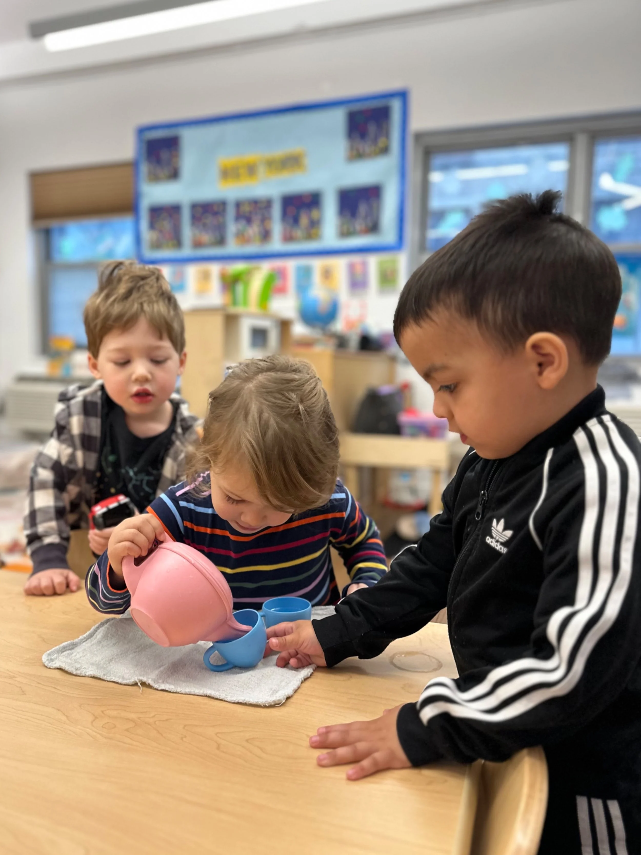 Three Preschool kids playing "Afternoon Tea" together.