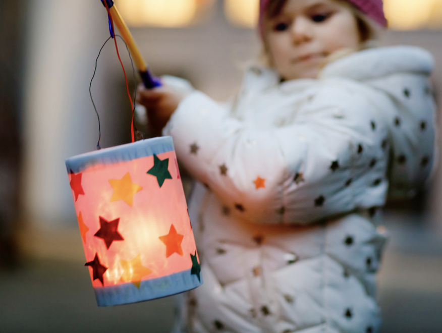 Child holding an illuminated lantern, part of Rella's Laternenlauf