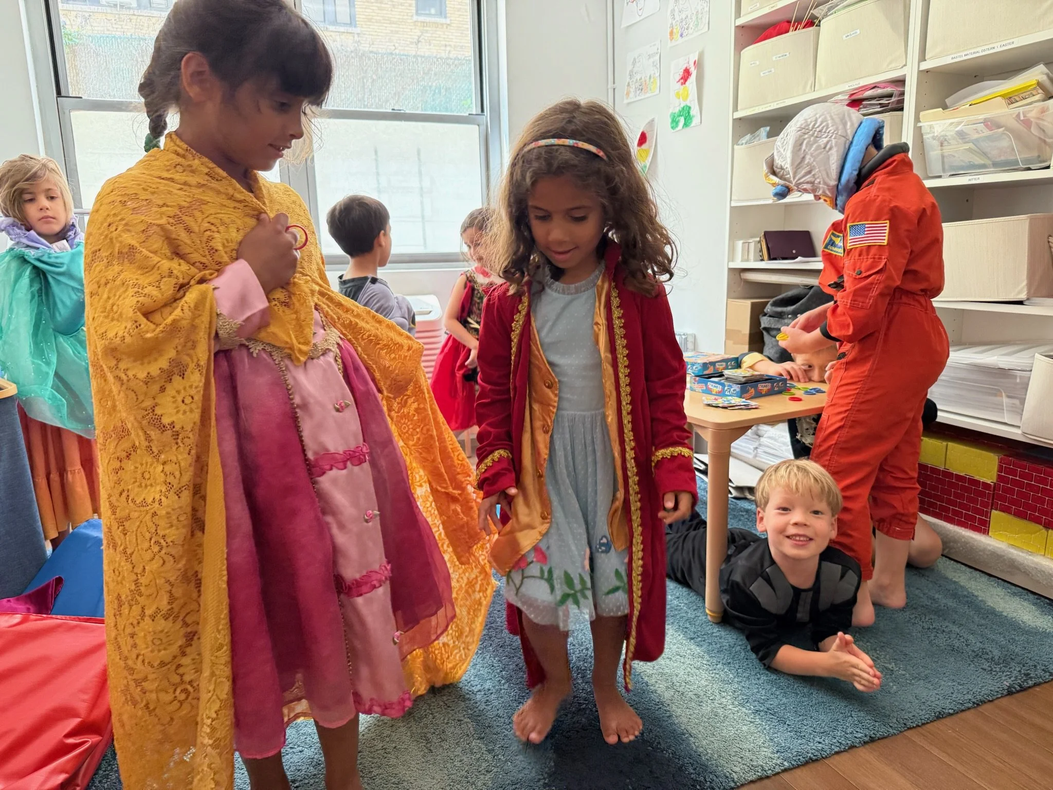 three girls trying on costumes