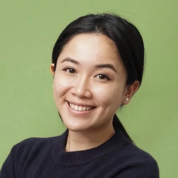 Female leader with a warm, confident smile.