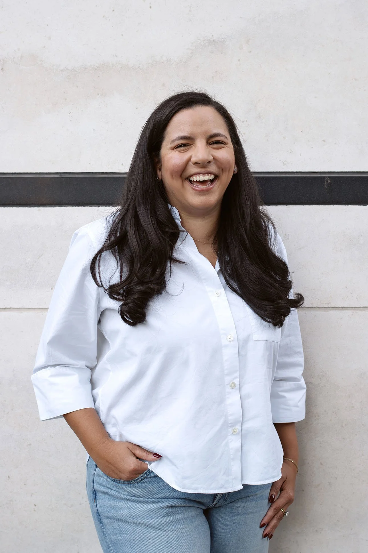 Headshot of Jessica smiling in a white button-up