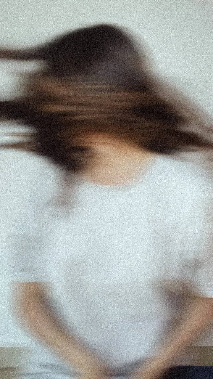 woman shaking head blurry