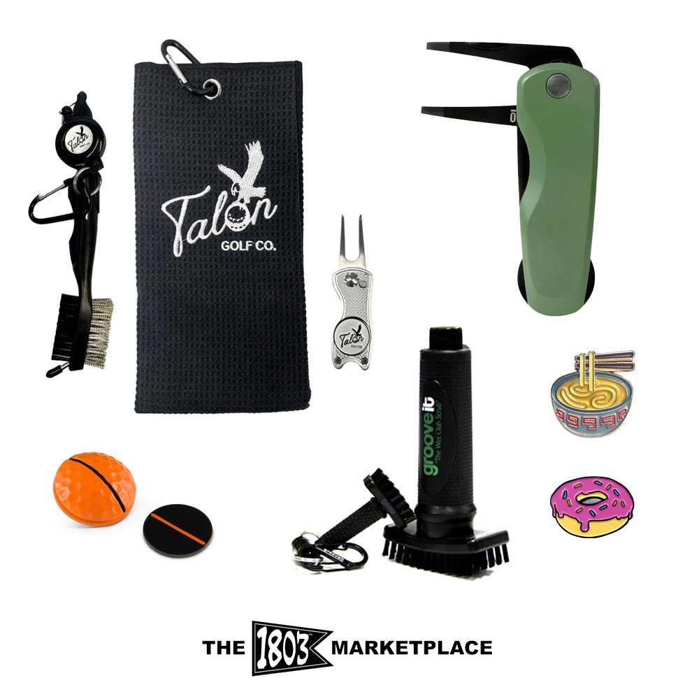 Collection of golf accessories and tools including a golf tee clip, towel, divot repair tool, golf ball marker, golf glove, golf brush, and small snack charms, with the logo of Talon Golf Co. and The 1803 Marketplace at the bottom.
