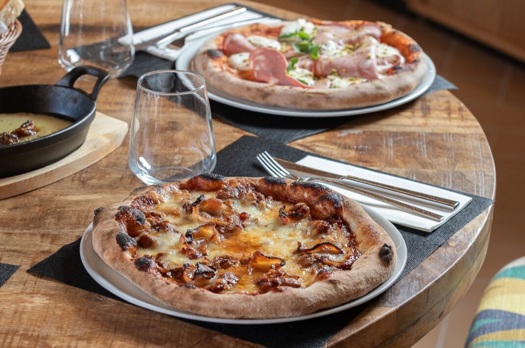 Two pizzas served on a table at the restaurant Don Giacomo in Oliva Nova