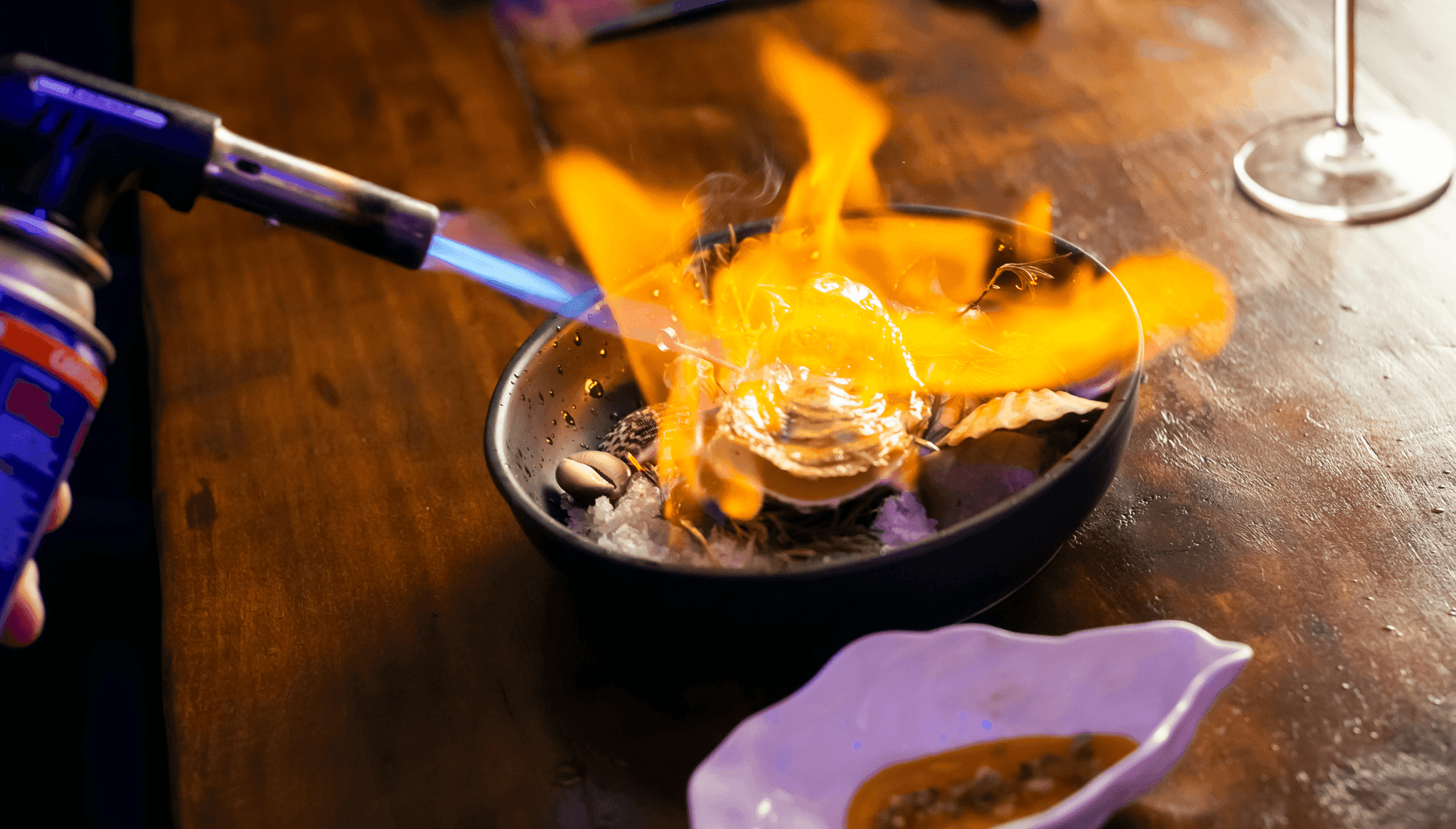 A dish being flambéed at Ossadía Restaurant in Denia