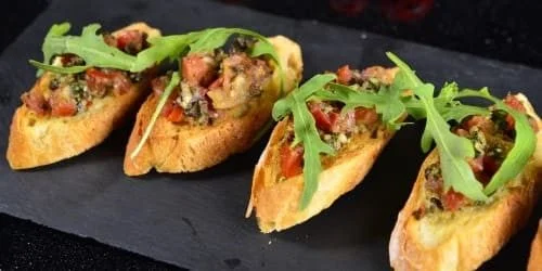 Pintxos served on a stone plate at Rei Jaume restaurant in Pedreguer