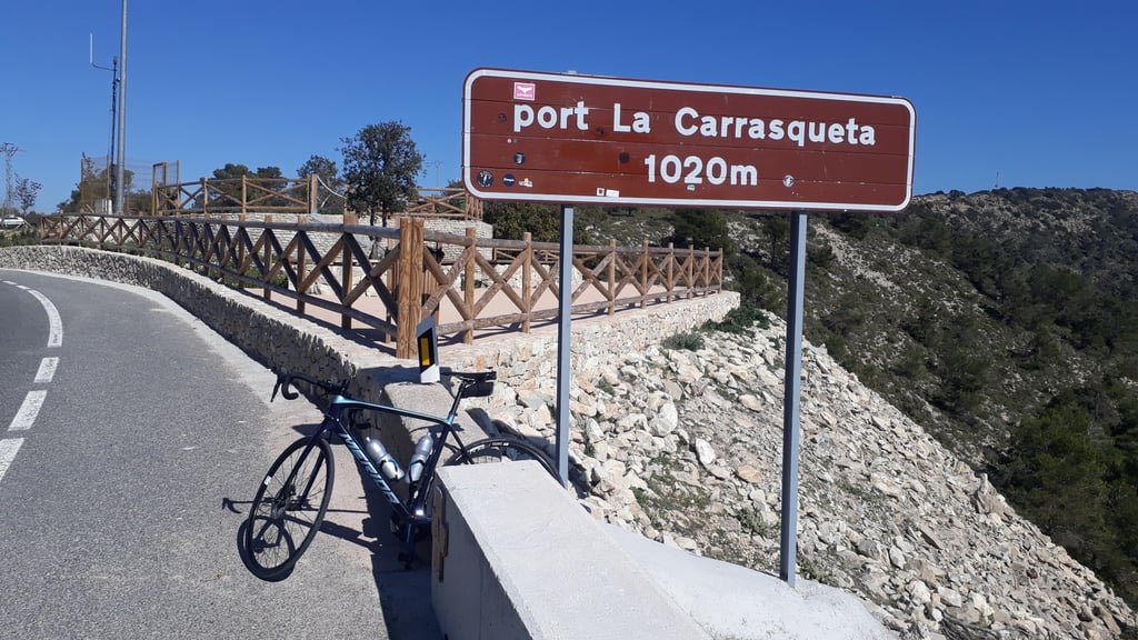 A bike parked in front of the mountain pass sign of Port La Carrasqueta