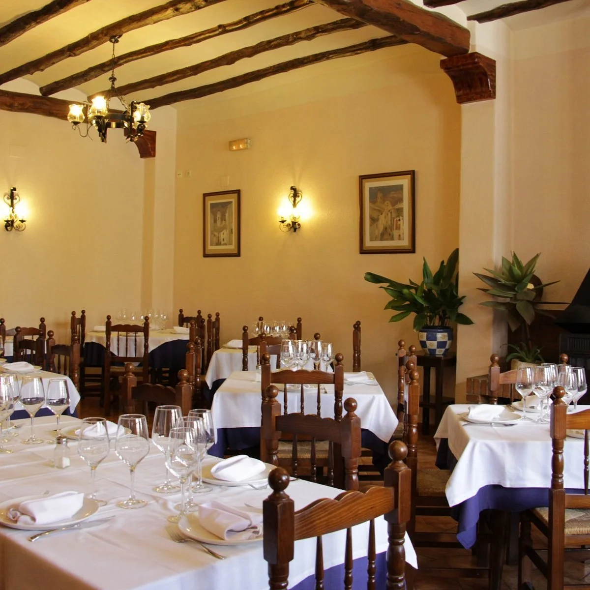 Set tables in the dining room of Ca Rafel restaurant in Benimantell