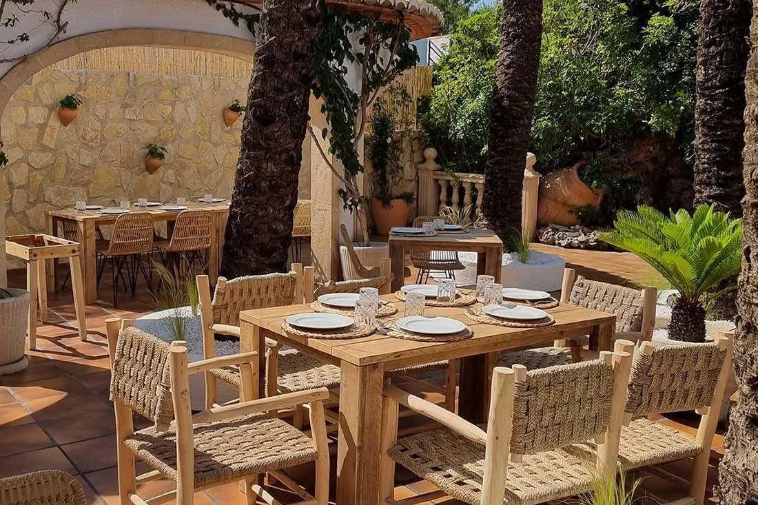 Wood tables set for a meal at the Oasis Restaurant in Jávea